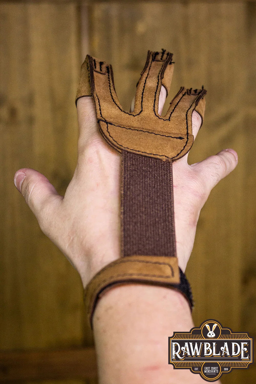 Archery Glove Kane worn on hand showing three finger design and adjustable velcro strap.