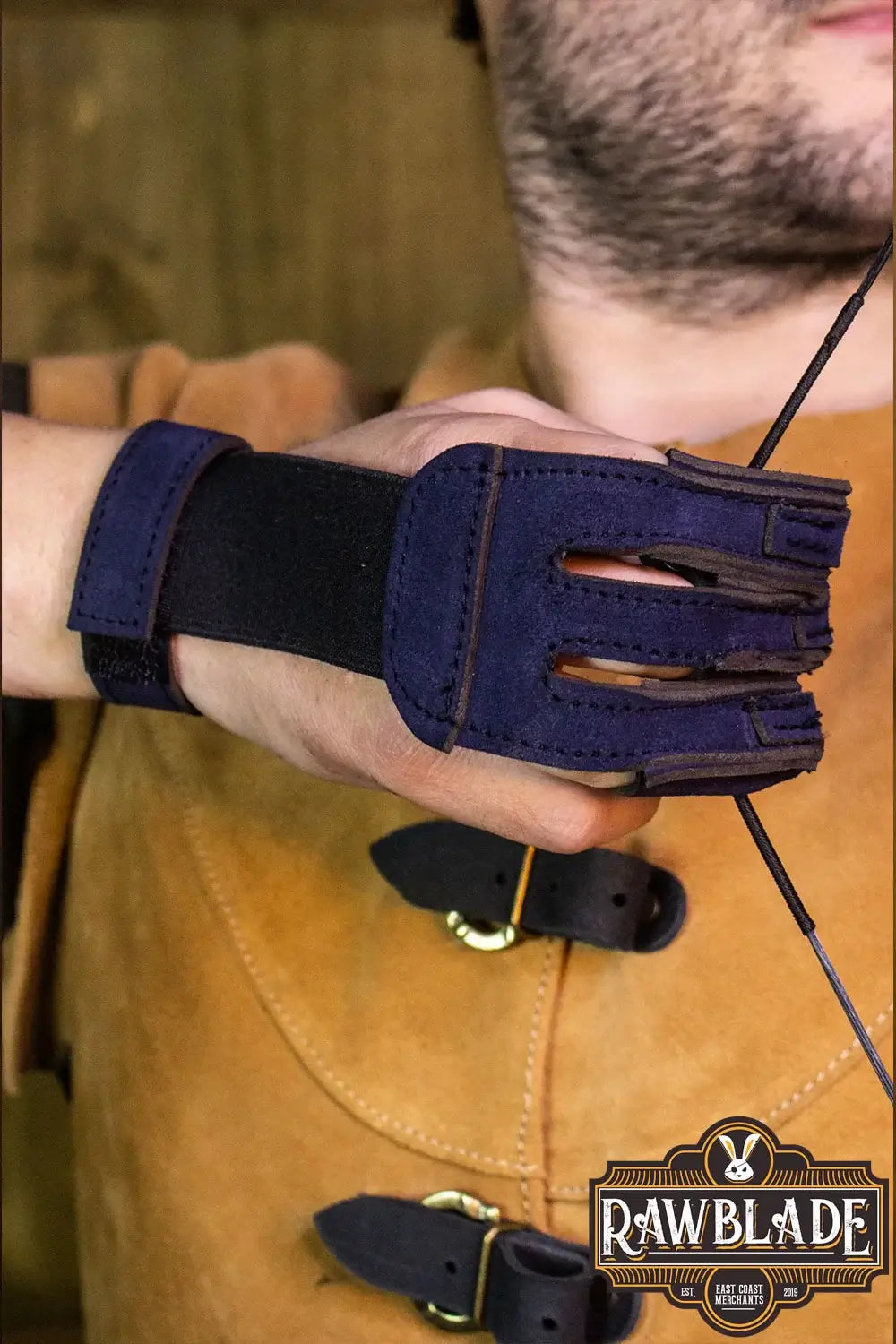 Model wearing Archery Glove Kane, a three finger glove made with high quality leather, showing wrist adjustment.