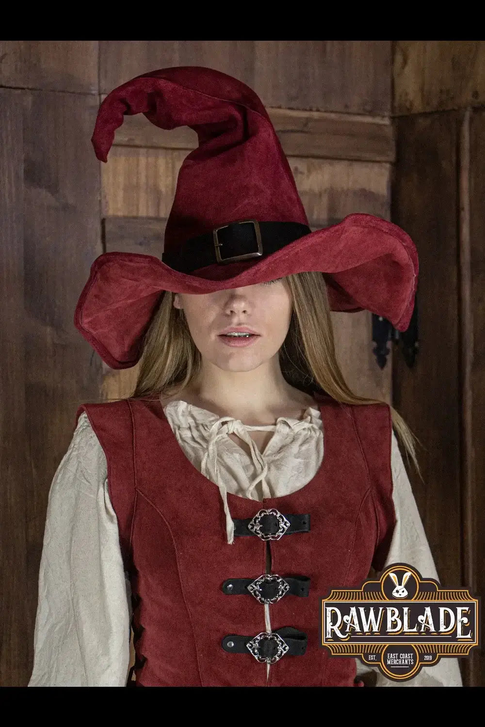 Wikka The Witch Hat Split Leather in red worn by a model, showcasing its unique pointed design and winged finish.