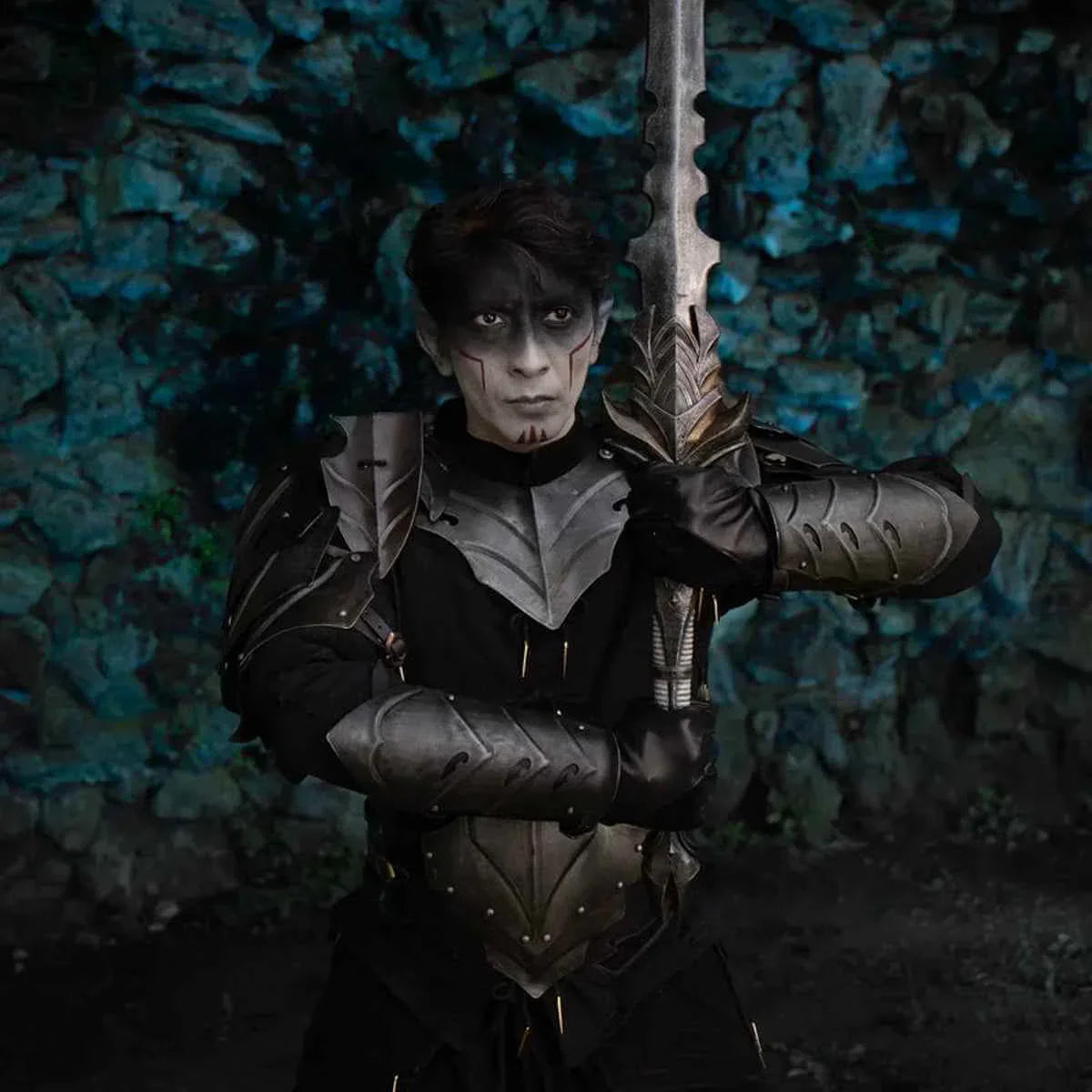 Cosplayer dressed as a warrior holding a sword, showcasing a striking look for Eventide.