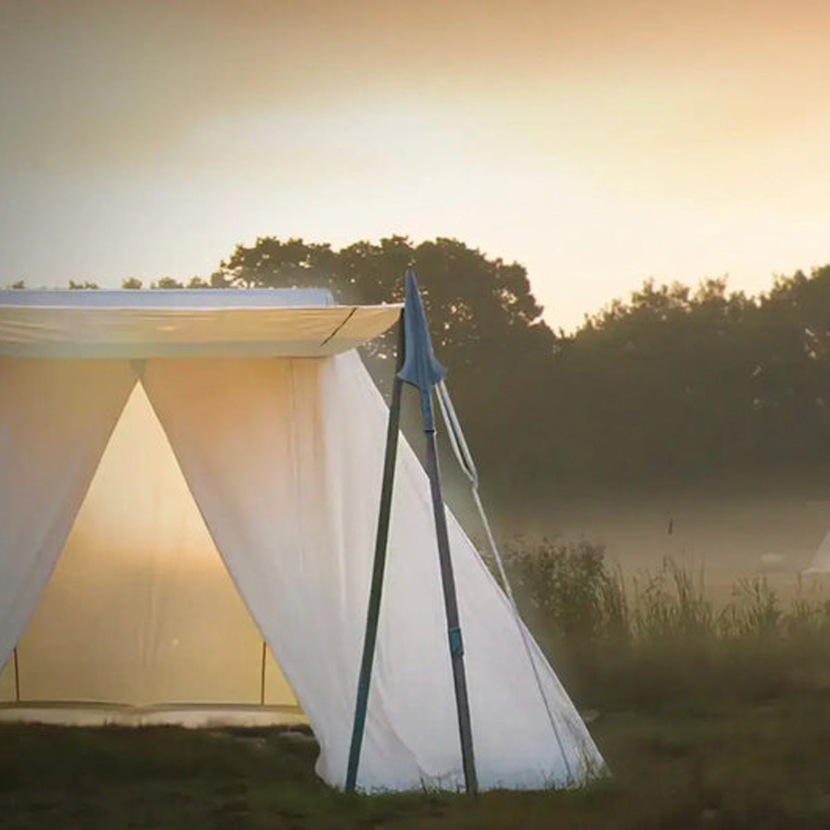 Solid Tent Solutions: A pristine tent illuminated by the sunset in a serene outdoor setting.