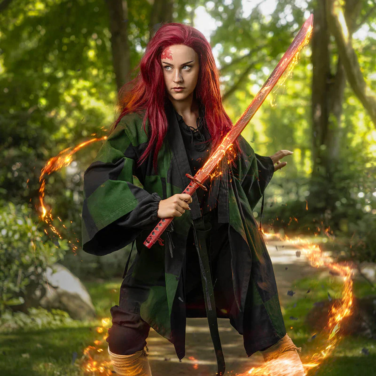 A warrior cosplaying with a Stronghold Katanas, surrounded by flames in a lush green setting.