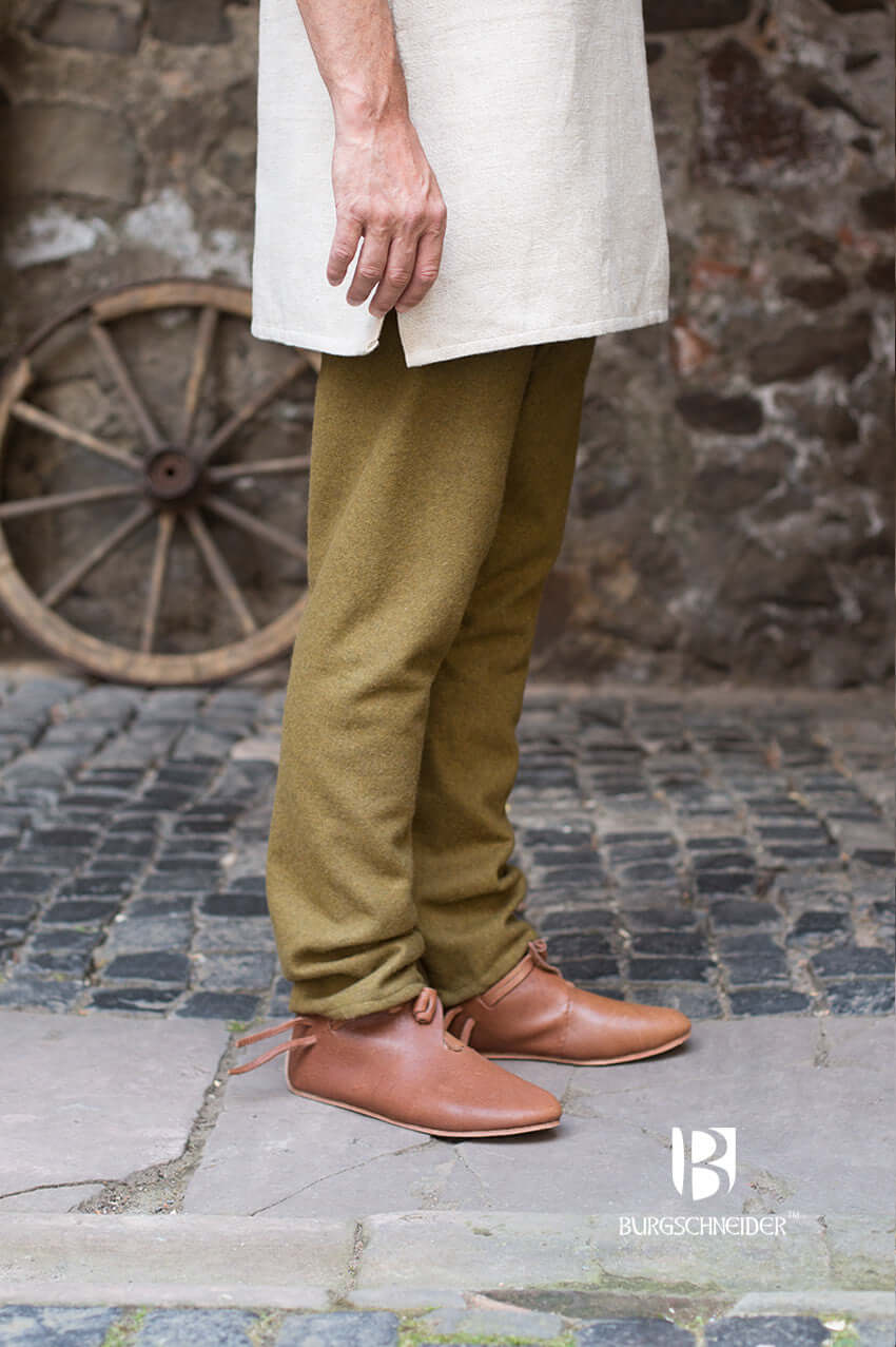 Wool Thorsberg Pants Fenris in Autumn Green, worn with a light tunic and leather shoes, authentic Viking style.