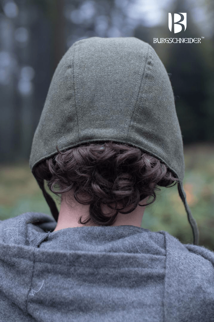 Back view of a person wearing the Bundling Hood Wolfram made by Burgschneider in a forest setting.