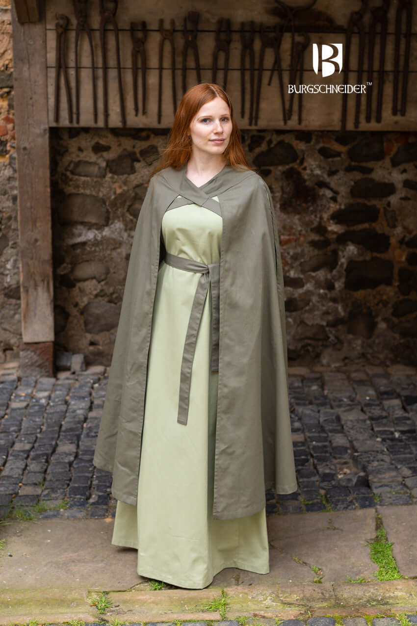 Model wearing the Cape Morpheus by Burgschneider, featuring striking straps and lightweight cotton material.