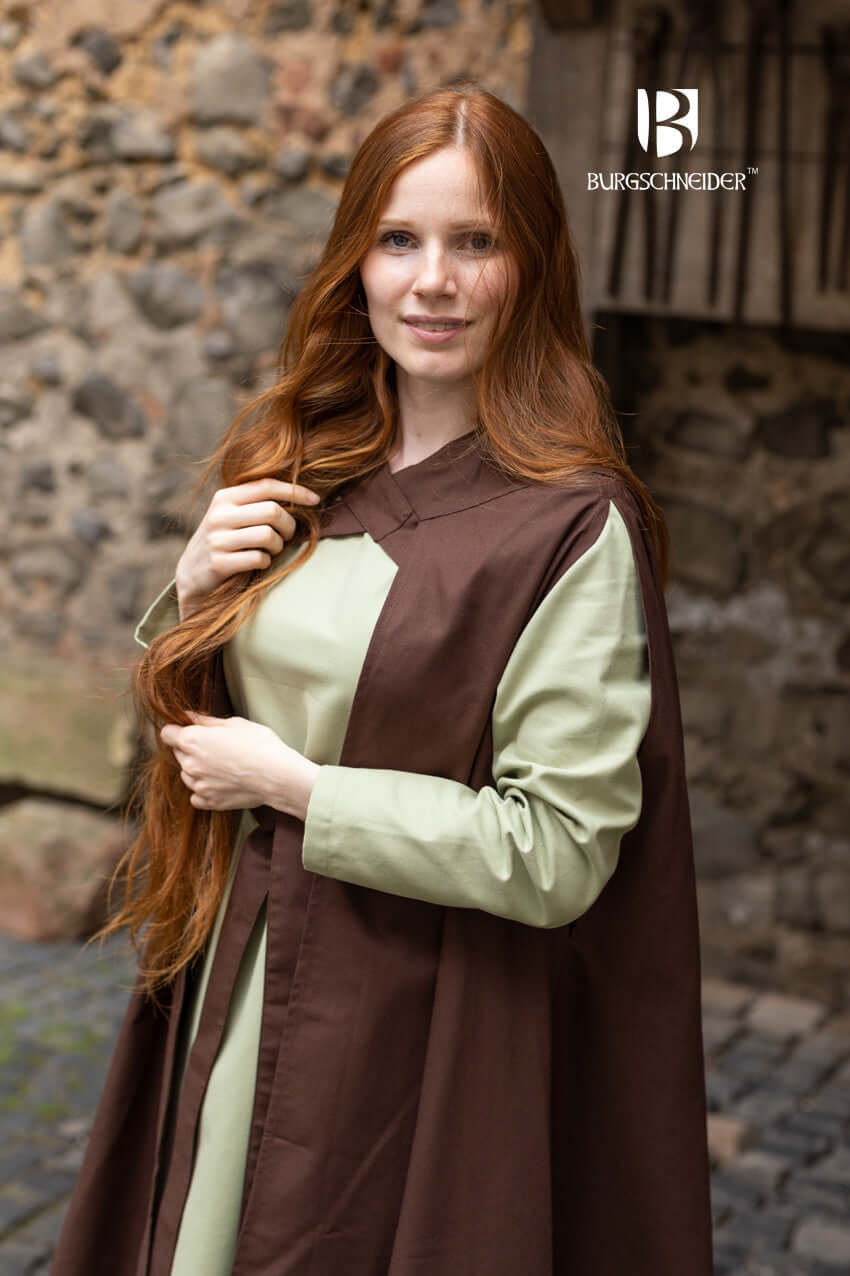 Cape Morpheus worn by a woman with long red hair, showcasing its lighter cotton design and stylish bindings.