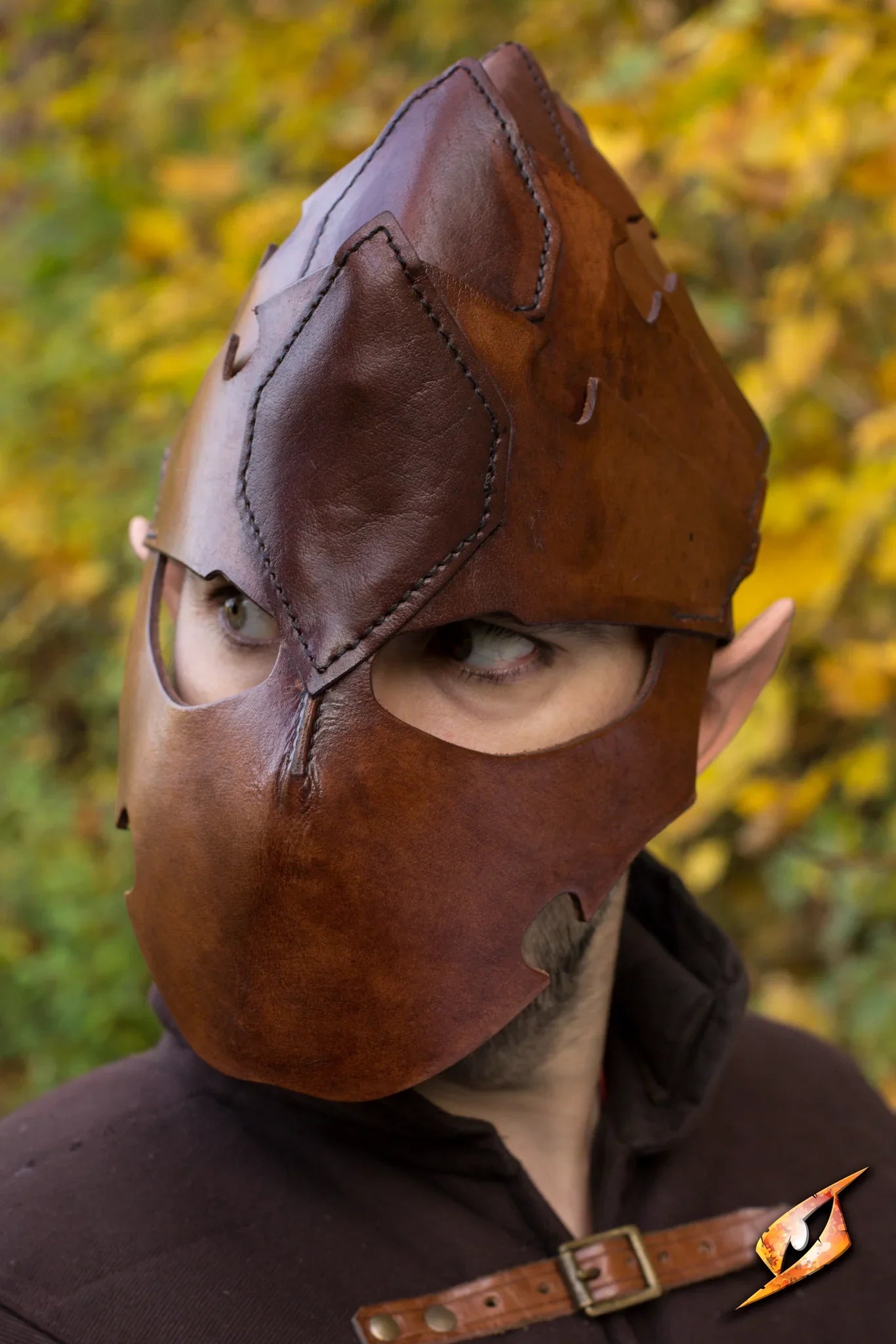Assassin Helmet worn by a character, showcasing detailed leather craftsmanship in an outdoor setting.
