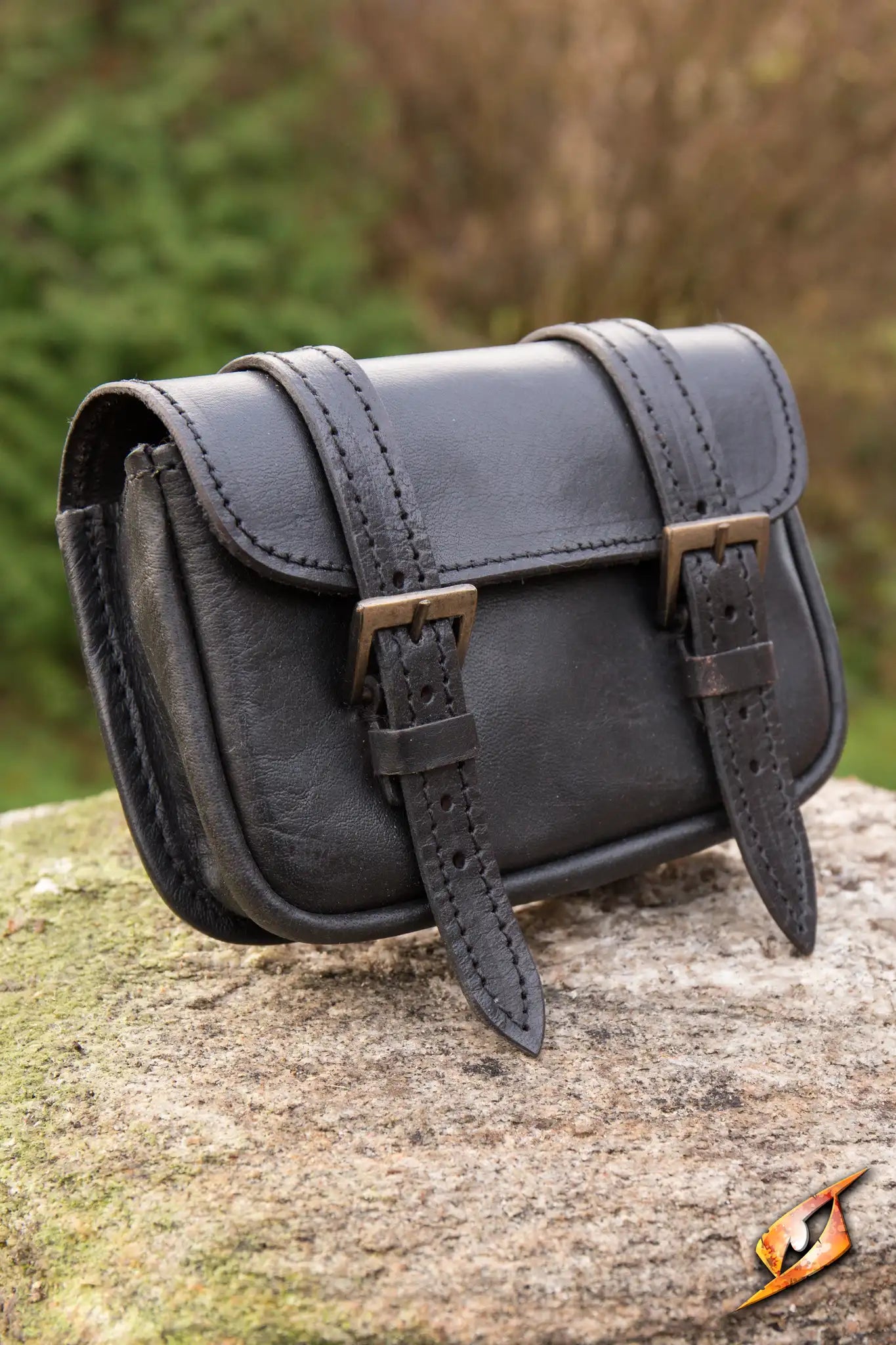 Warrior Bag - Large displayed on a stone, showcasing its sleek design and sturdy straps.