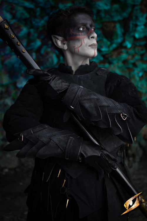Person wearing Shadow Armour Set - Suede, holding a staff, with dramatic face paint in a shadowy forest setting.