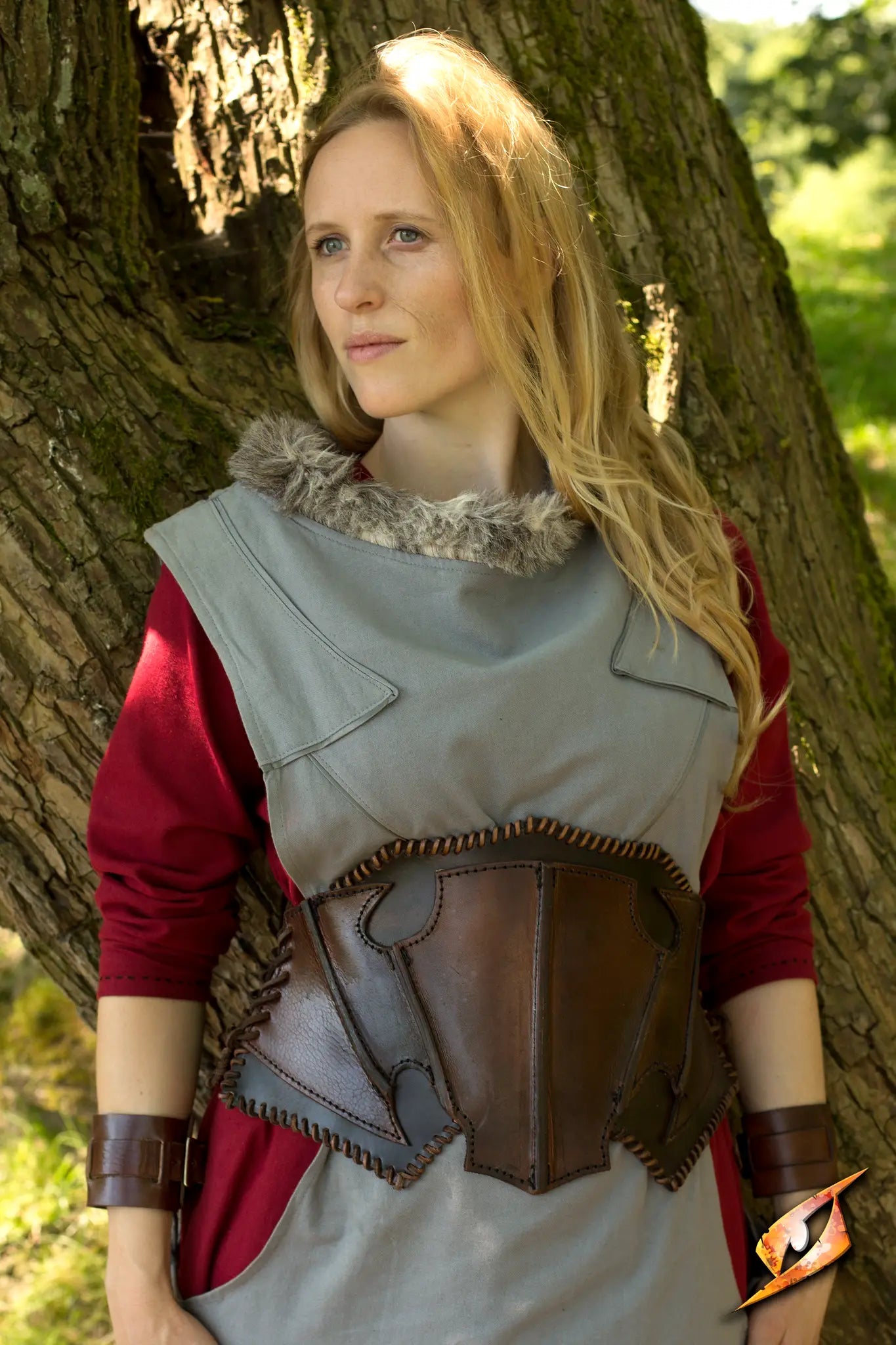 A model in a Dark Elf Corset stands in nature, showcasing the unique elven design and craftsmanship of the outfit.