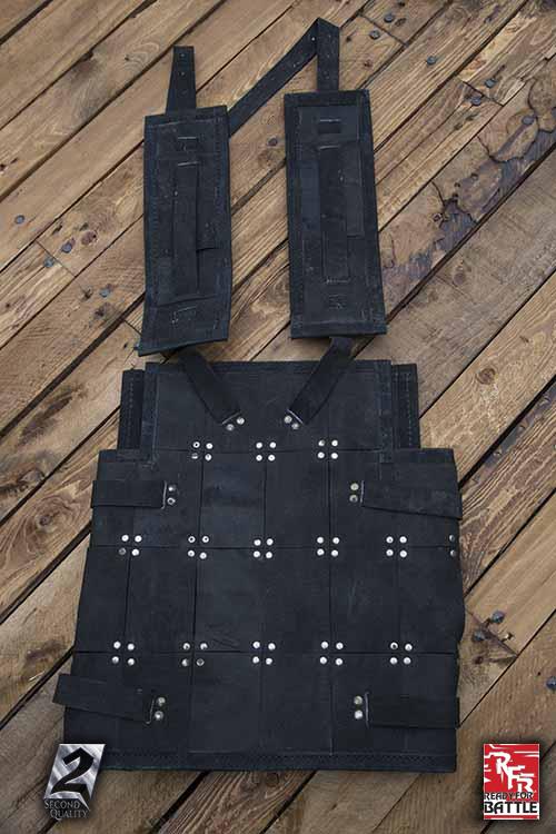 2Q - RFB Fighter Leather Armour displayed on wooden surface, showcasing its rugged design and sturdy construction.