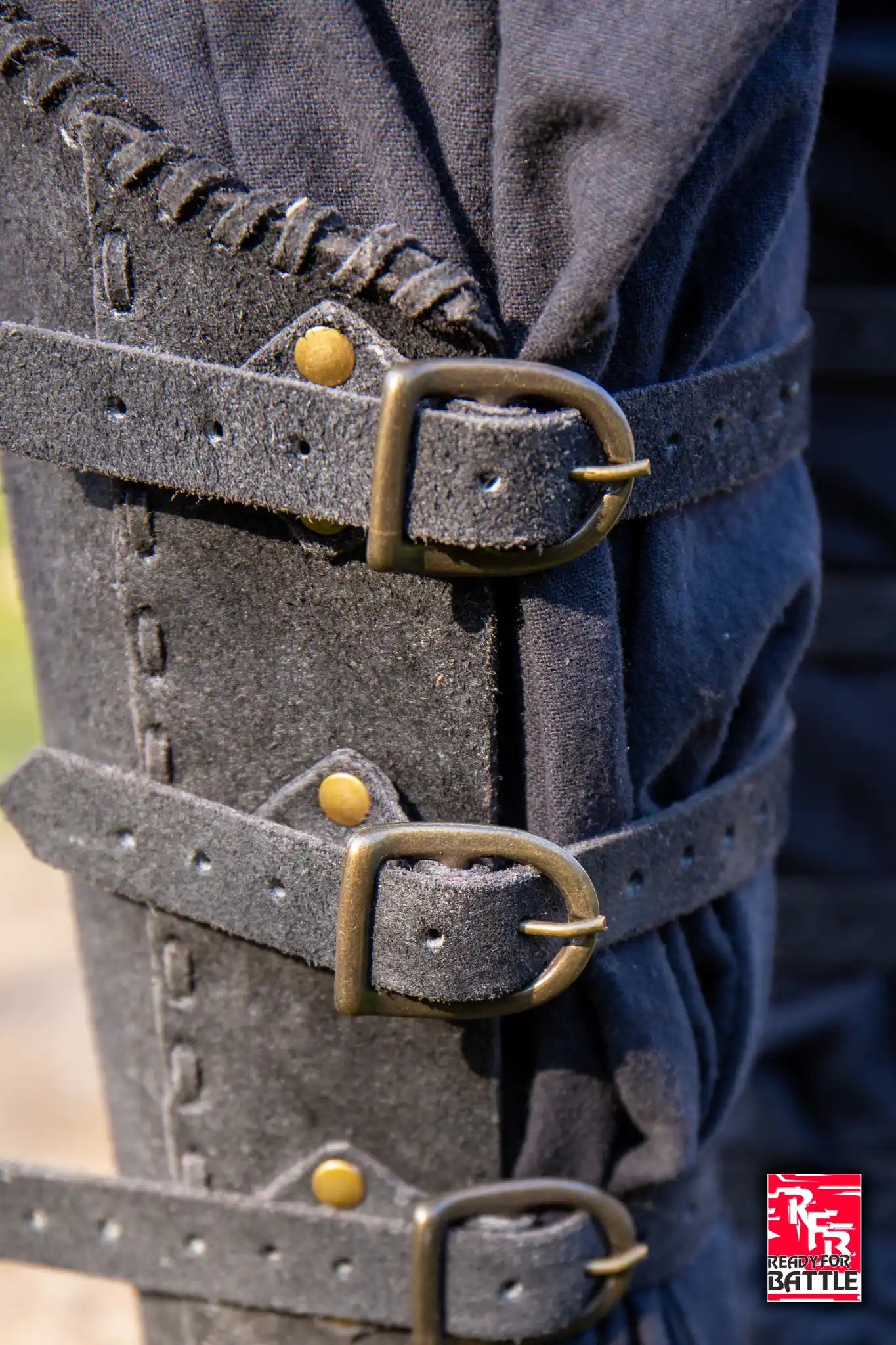 Close-up of RFB Veteran Greaves showing sturdy leather straps and buckle details, highlighting protection and craftsmanship.