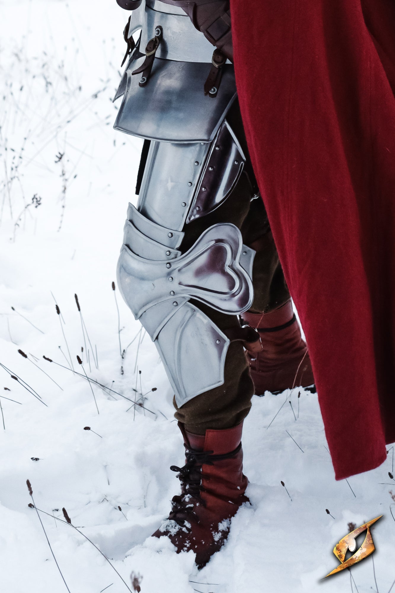 Gothic Leg Protection showcased in snow, featuring articulated poleyns and cuisses for enhanced leg armor.