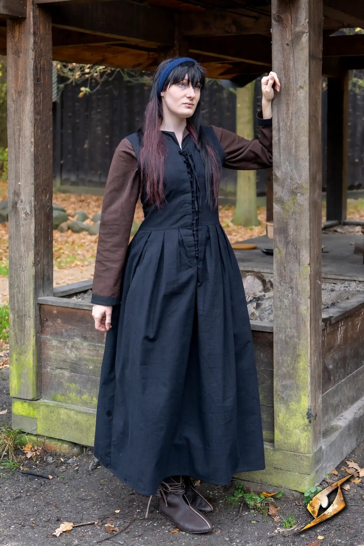Model wearing the Adelina Dress in black and brown, perfect for medieval or renaissance events.