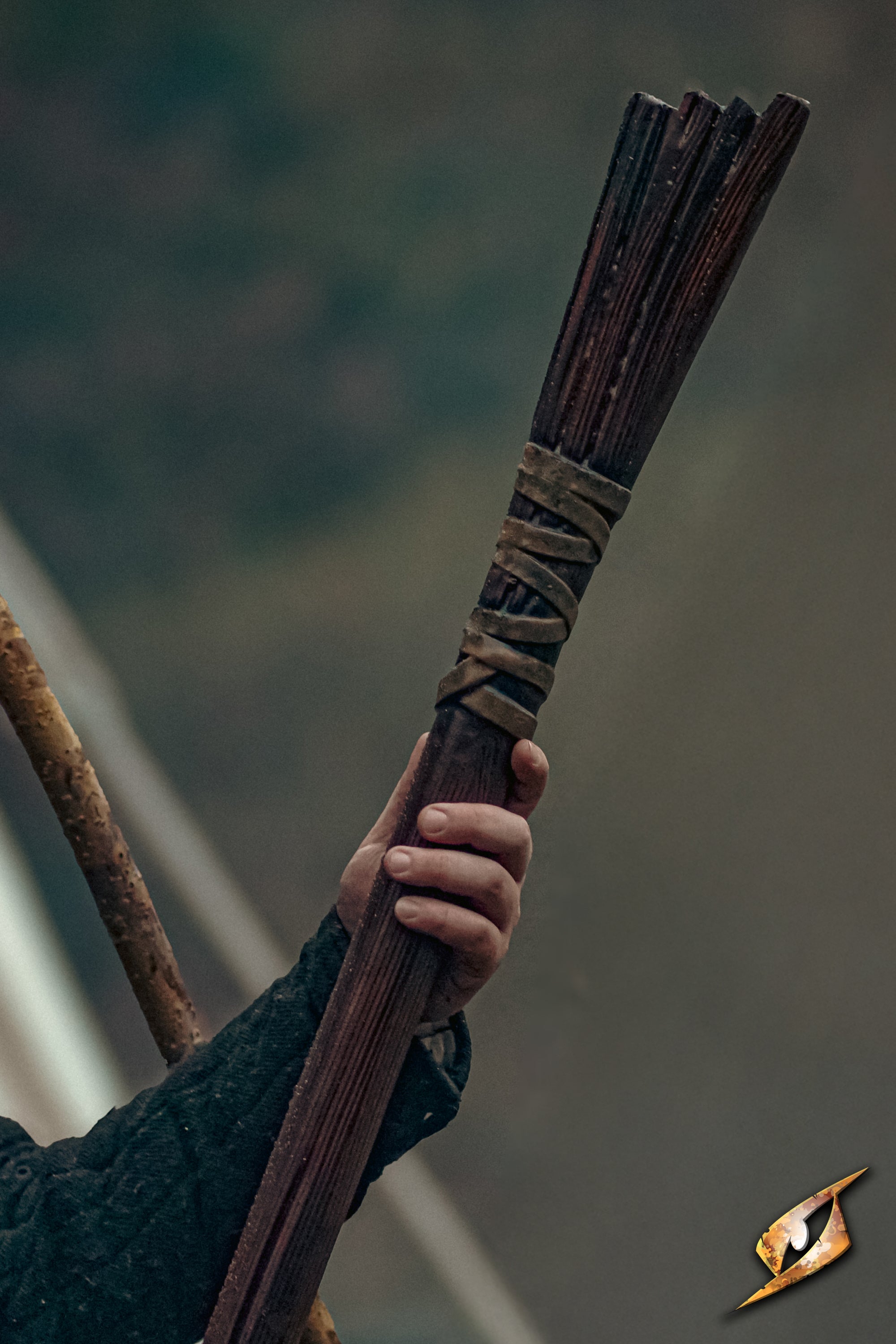 Wooden Staff held by a person with leather bindings and detailed worn wood appearance.