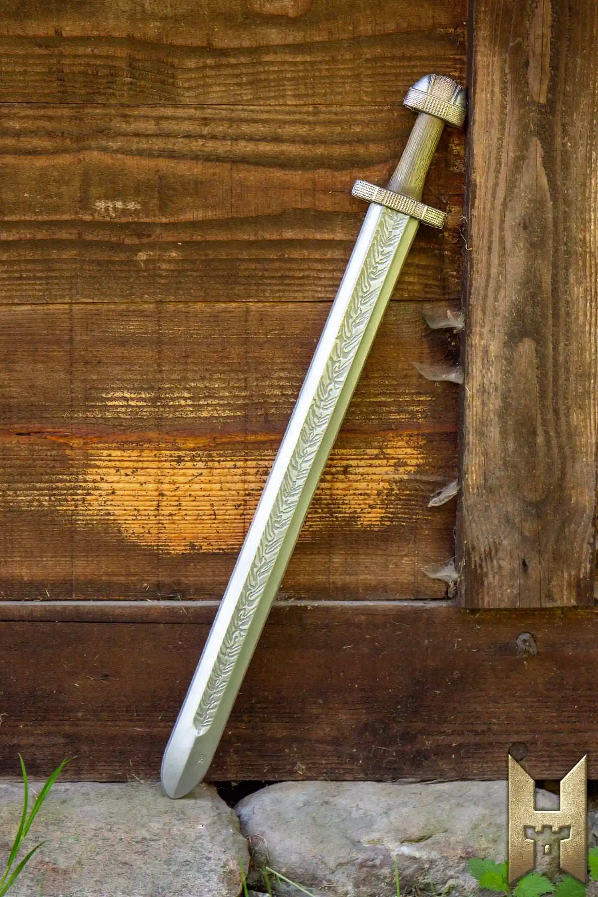 EirikR Sword - 83 cm leaning against a wooden wall, showcasing its historical design and craftsmanship.