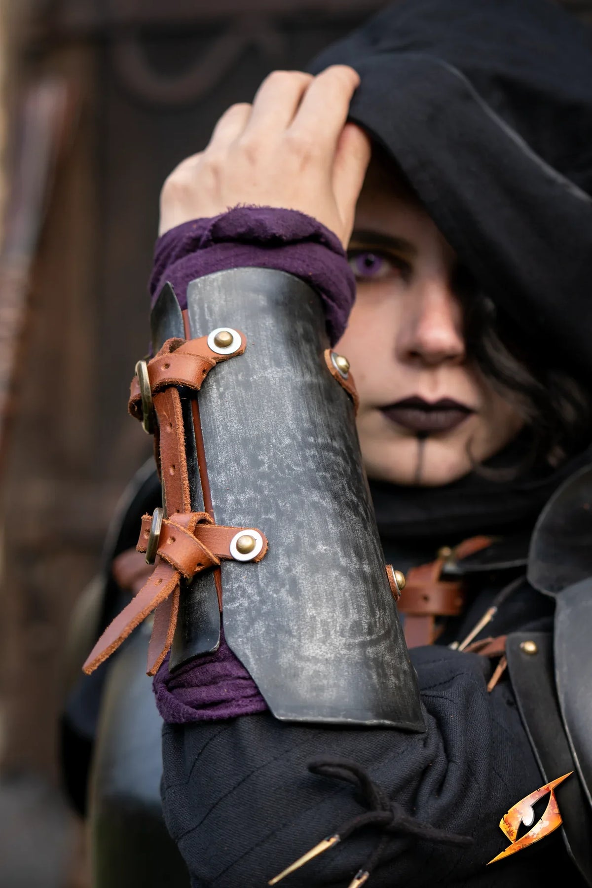 Renegade Vambraces showcased on a model, highlighting the steel craftsmanship and leather straps.