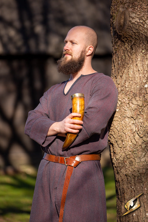 Warrior drinking horn 0,5 L held by a man in historical attire standing beside a tree in a meadow.