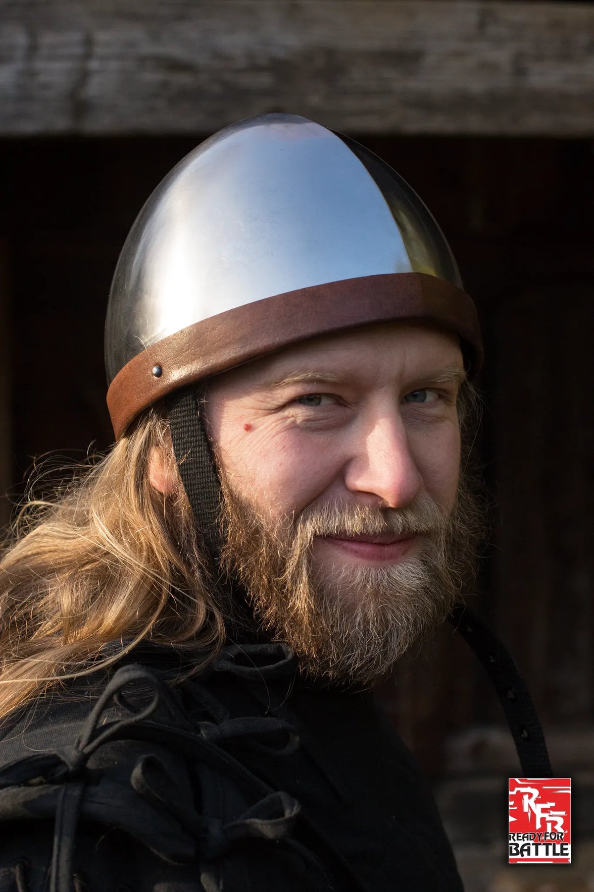 Person wearing an RFB Helmet, prepared for battle with a confident expression and a rustic background.