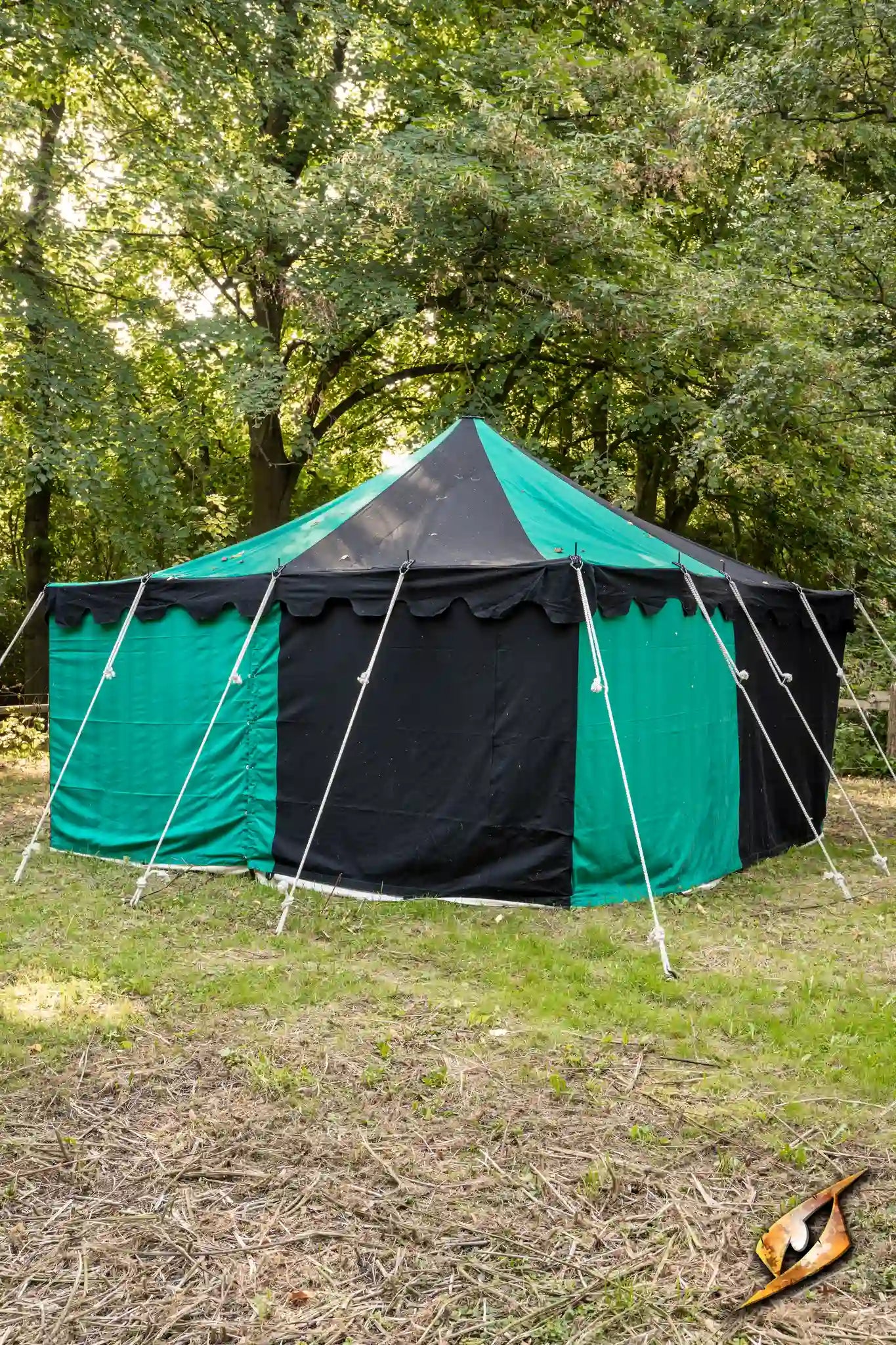 Marquee Tent - 4x4m in a green and black setting surrounded by trees.