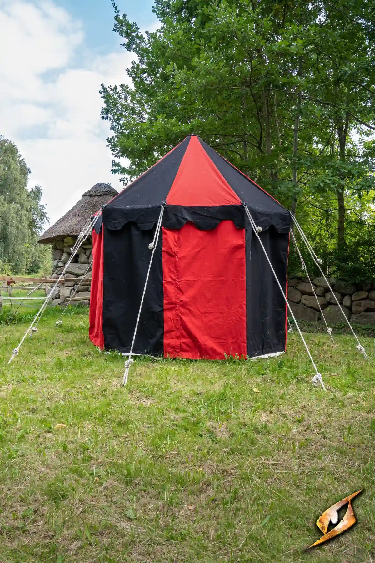 Round Pavilion Tent - 3m set up in a grassy area with trees, featuring red and black panels.