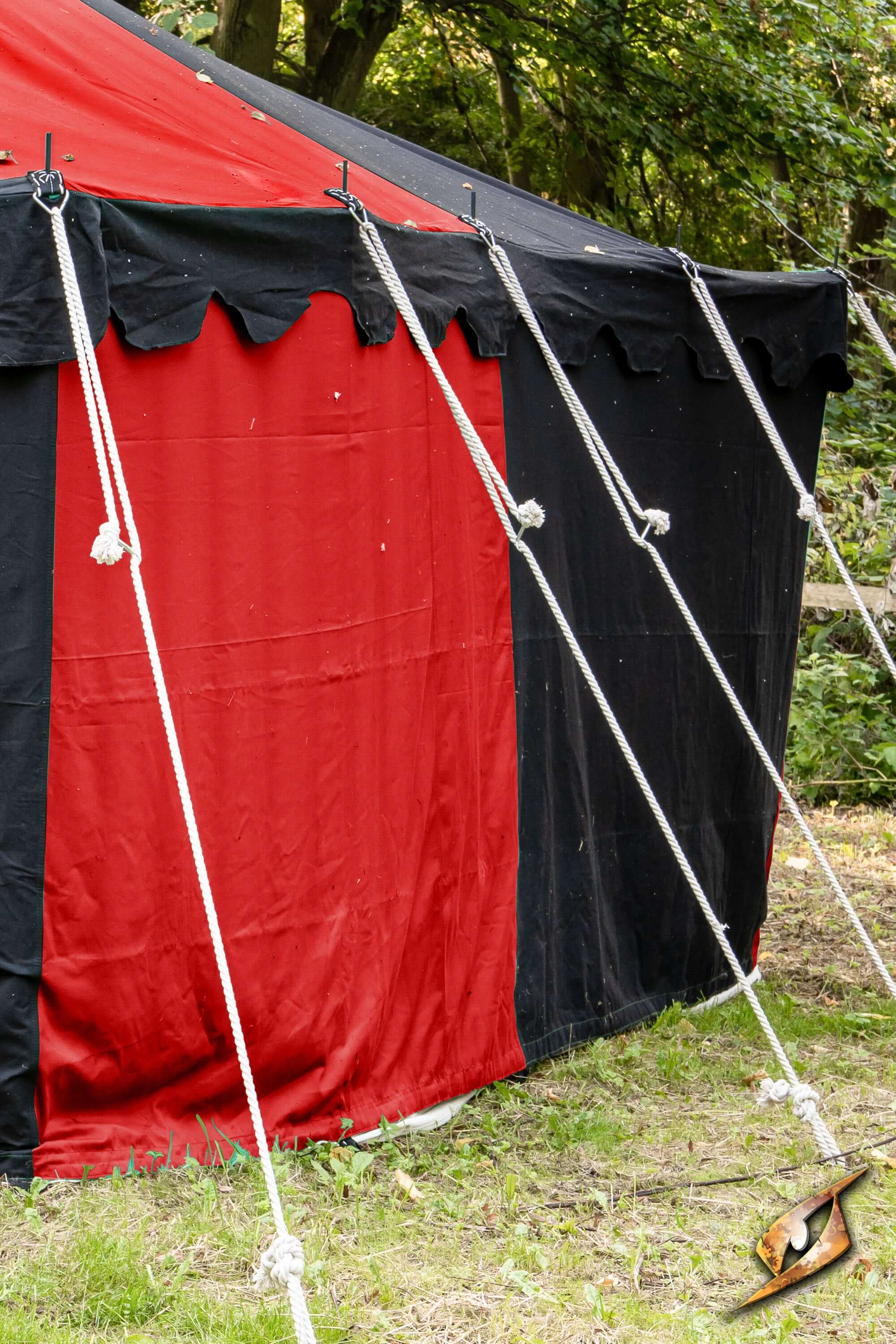 Marquee Tent - Sides - 5x8m with black and red fabric, secured by ropes and stakes in a natural setting.