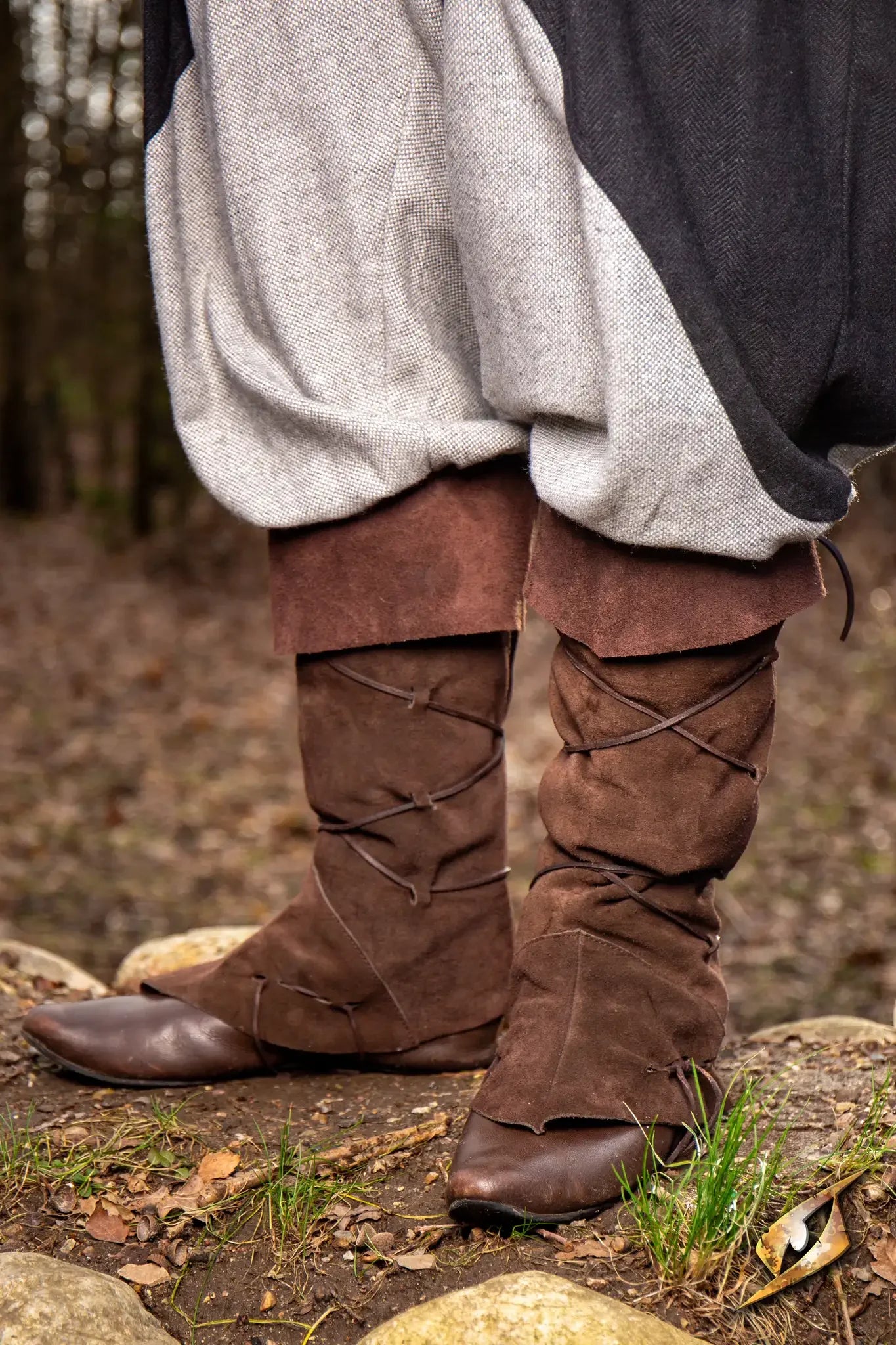 Theoderic gaiters worn outdoors, featuring brown suede and stylish lacing, perfect for muddy streets.