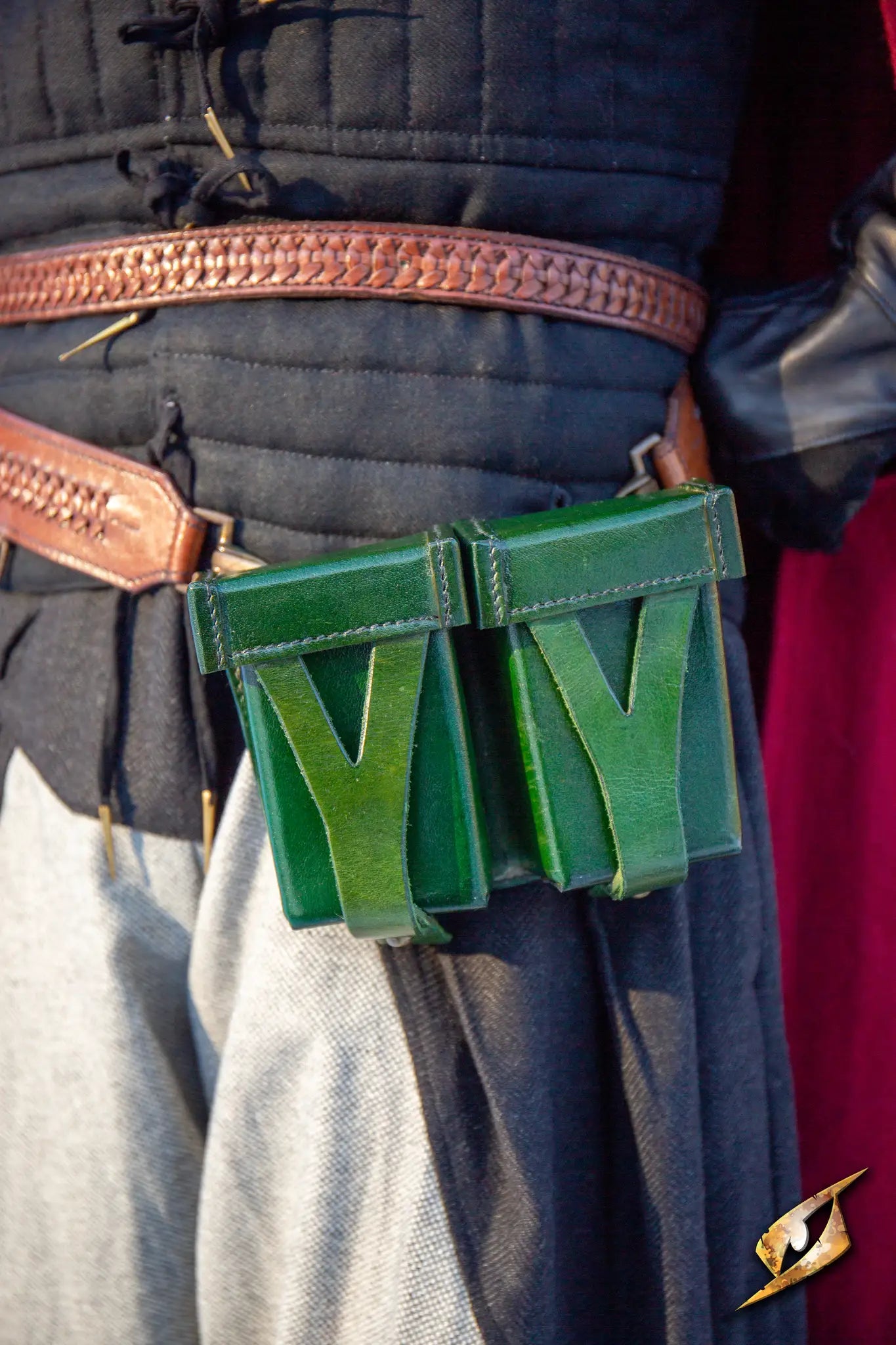 Hard Pouch For Sword Belt attached to a costume, featuring a green leather design on display.