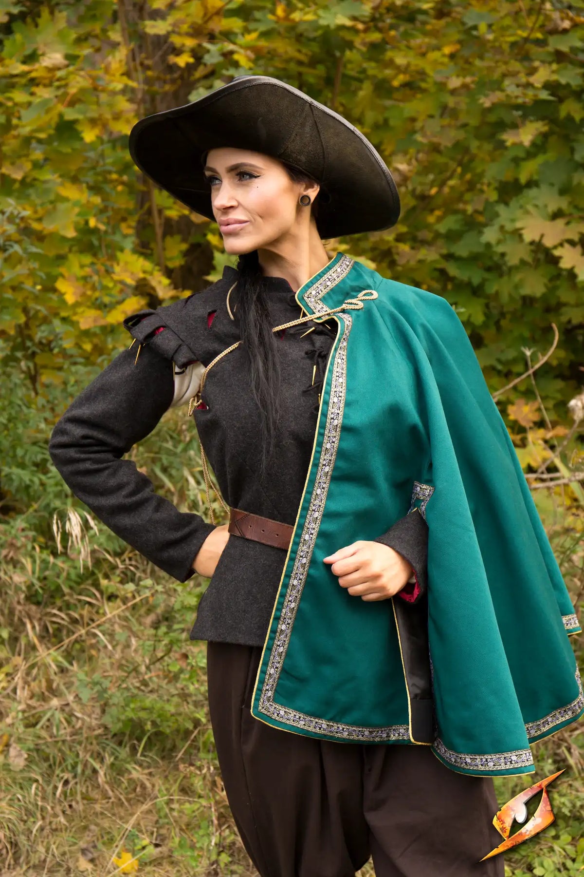 Cape Aramis worn by a model, featuring a high collar, decorative trim, and a stylish cape design.