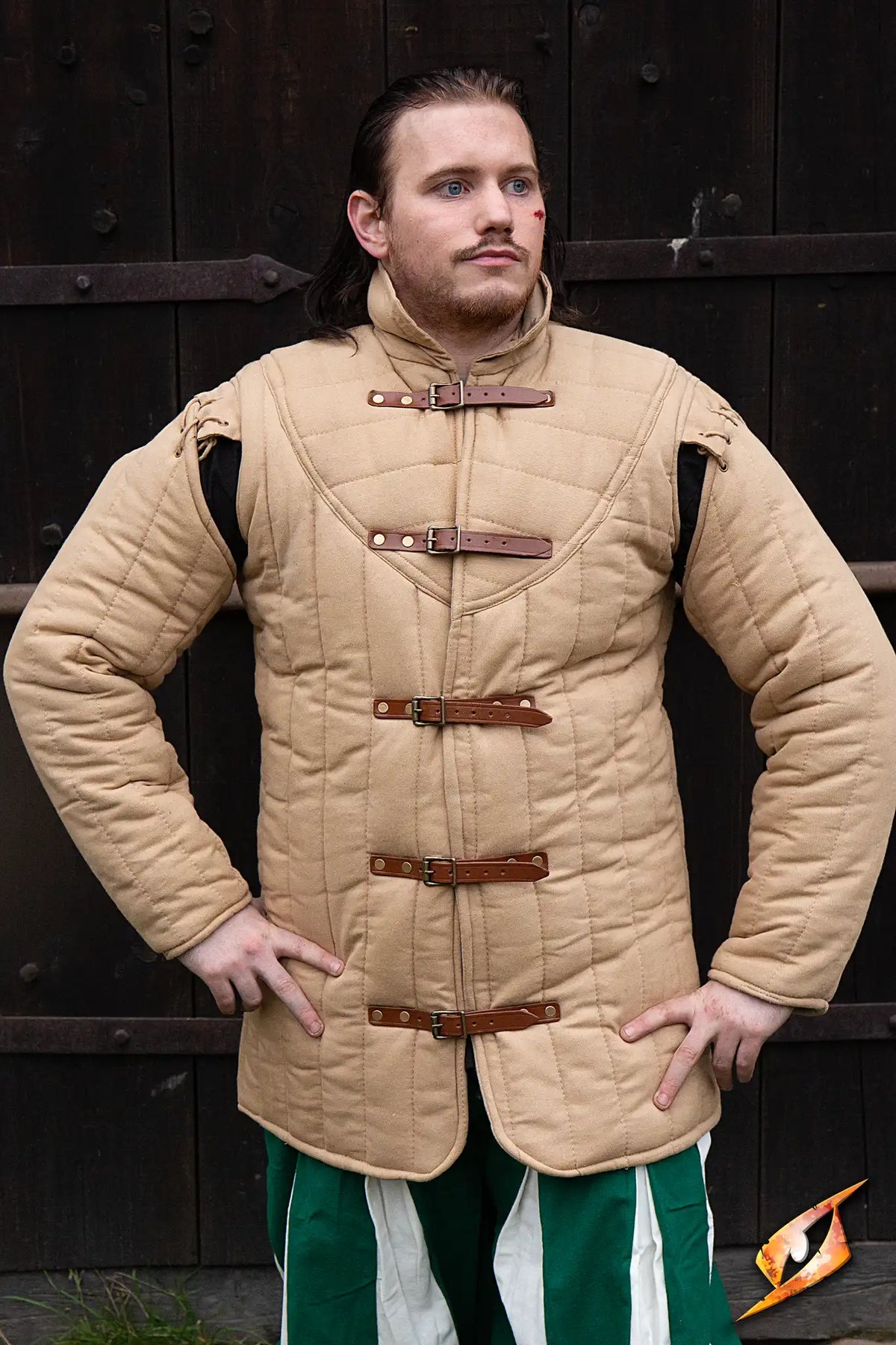 Gambeson Warrior With Long Sleeves worn by a man posing outdoors against a wooden backdrop.