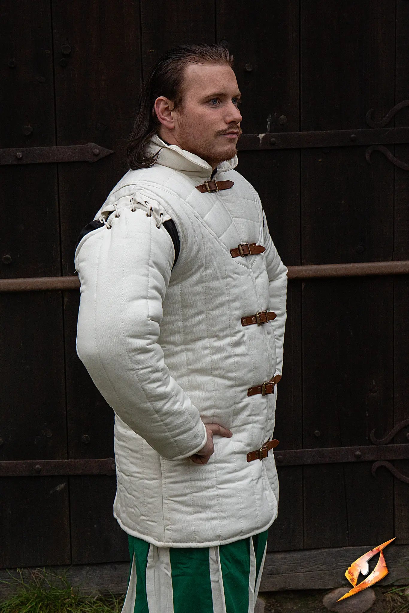 Gambeson Warrior With Long Sleeves worn by a male model showcasing side view in a historical setting.