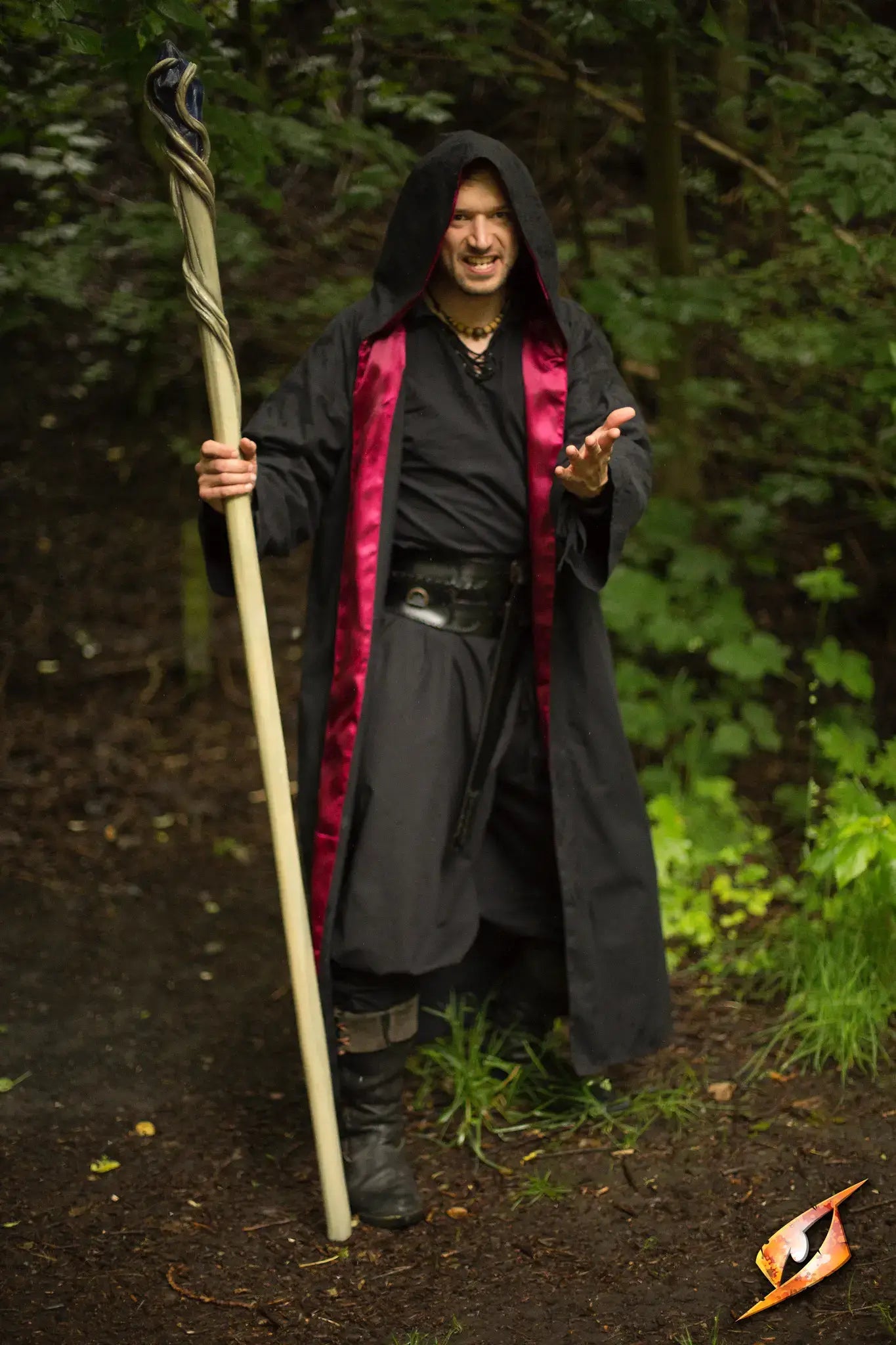 Magician Robe worn by a spell-caster wielding a staff, showcasing a powerful and mystical presence in nature.