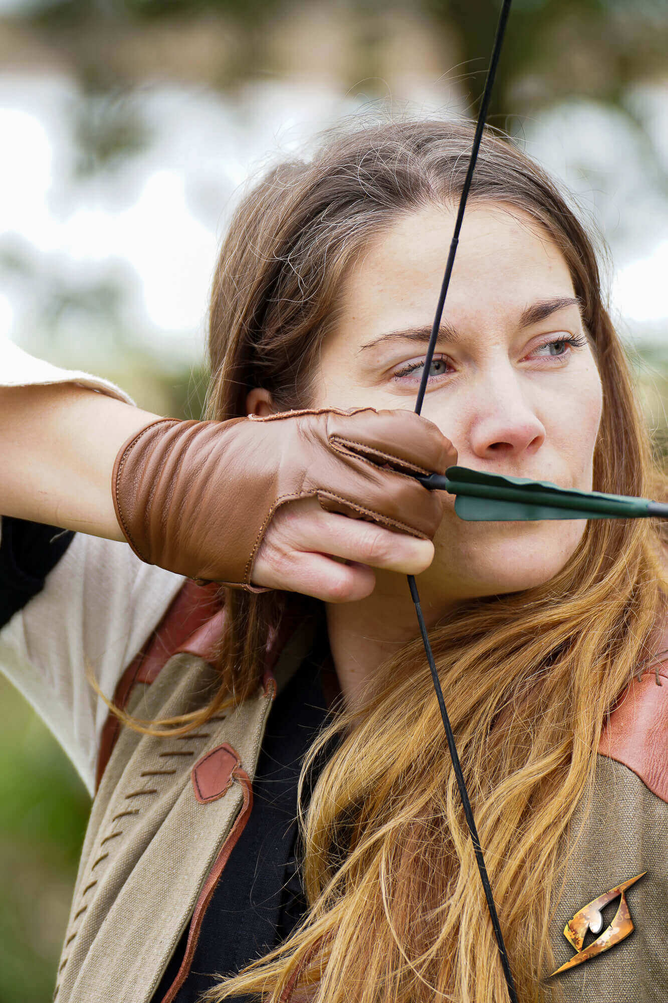Archery Half-glove worn by an archer, showcasing finger protection and dexterity in archery practice.