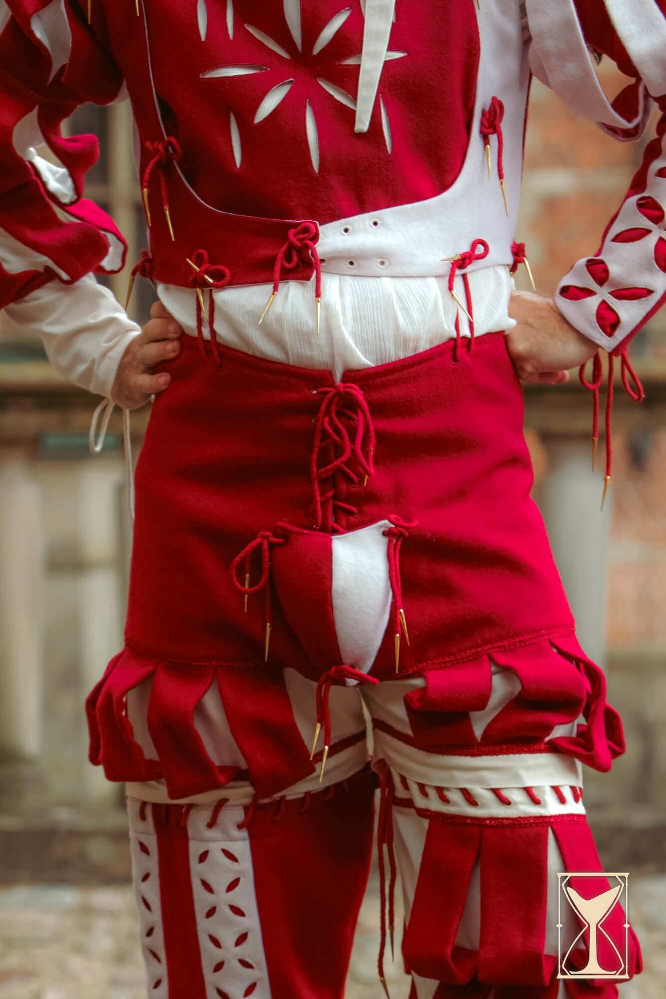 Landsknecht Breeches showcasing vibrant red and white design with slashes and historical styling.