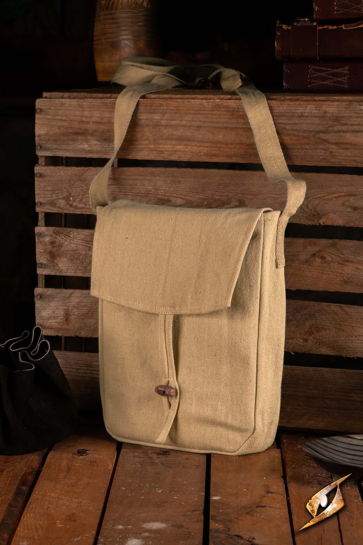 Traveler Satchel - Canvas hanging on a wooden crate, featuring a simple design, perfect for everyday use.