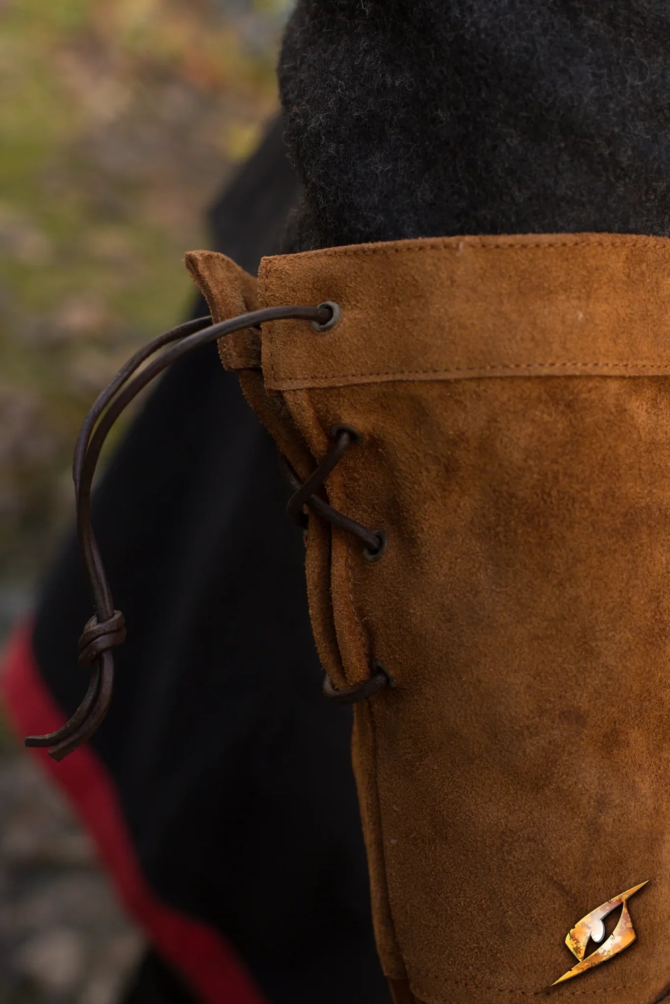 Close-up of high-quality leather gloves with stylish lacing detail for outdoor use.