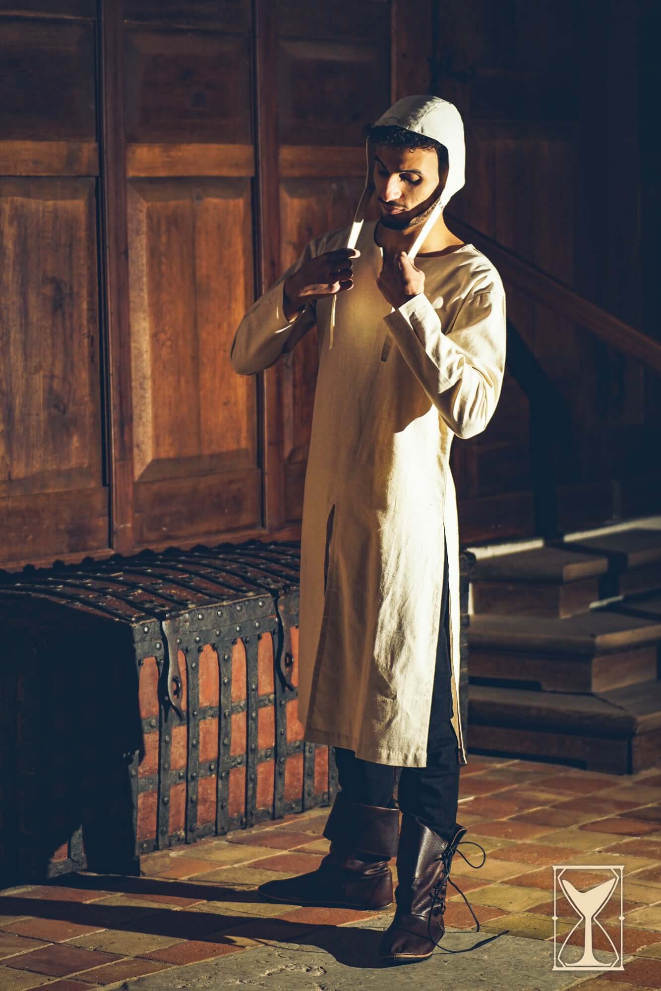 Medieval Riding Tunic worn by a model in a historic setting, showcasing movement and period design.