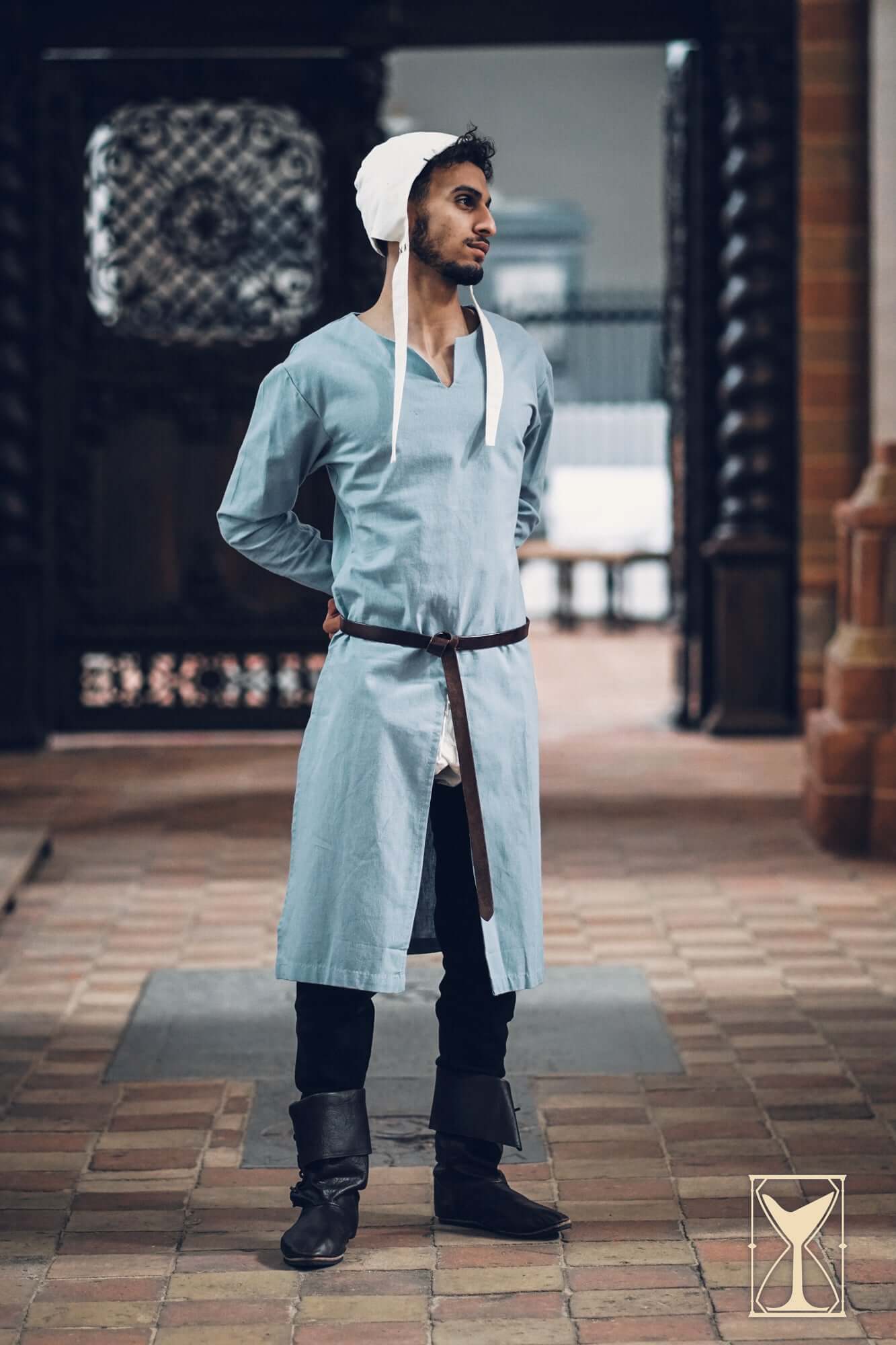 Medieval Riding Tunic modeled by a man, showcasing deep splits for mobility in a historical setting.