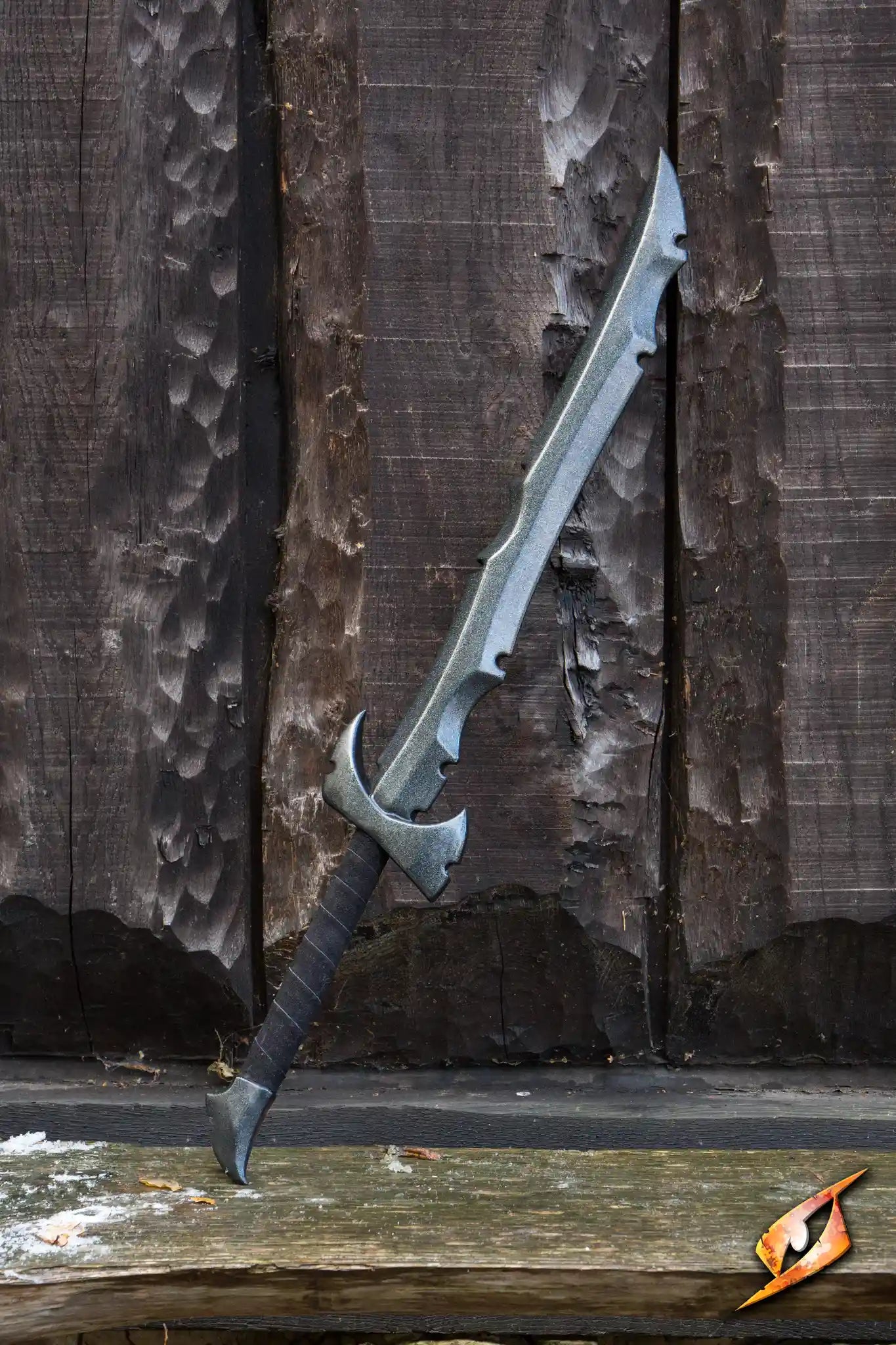 Assassin - 85 cm sword displayed against a rustic wooden background, showcasing its sleek design.
