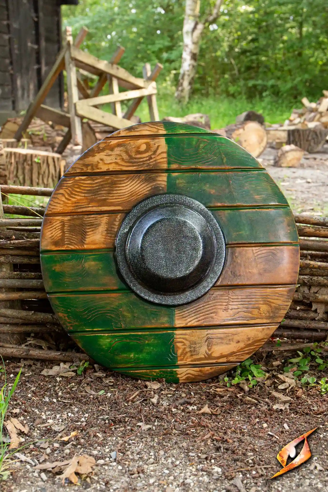 Drang Shield displayed against a rustic backdrop, featuring a textured wooden design with green and brown colors.