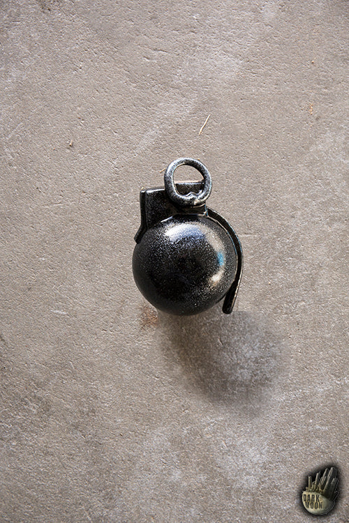 Hand Grenade resting on a gray surface, showcasing its design and features.