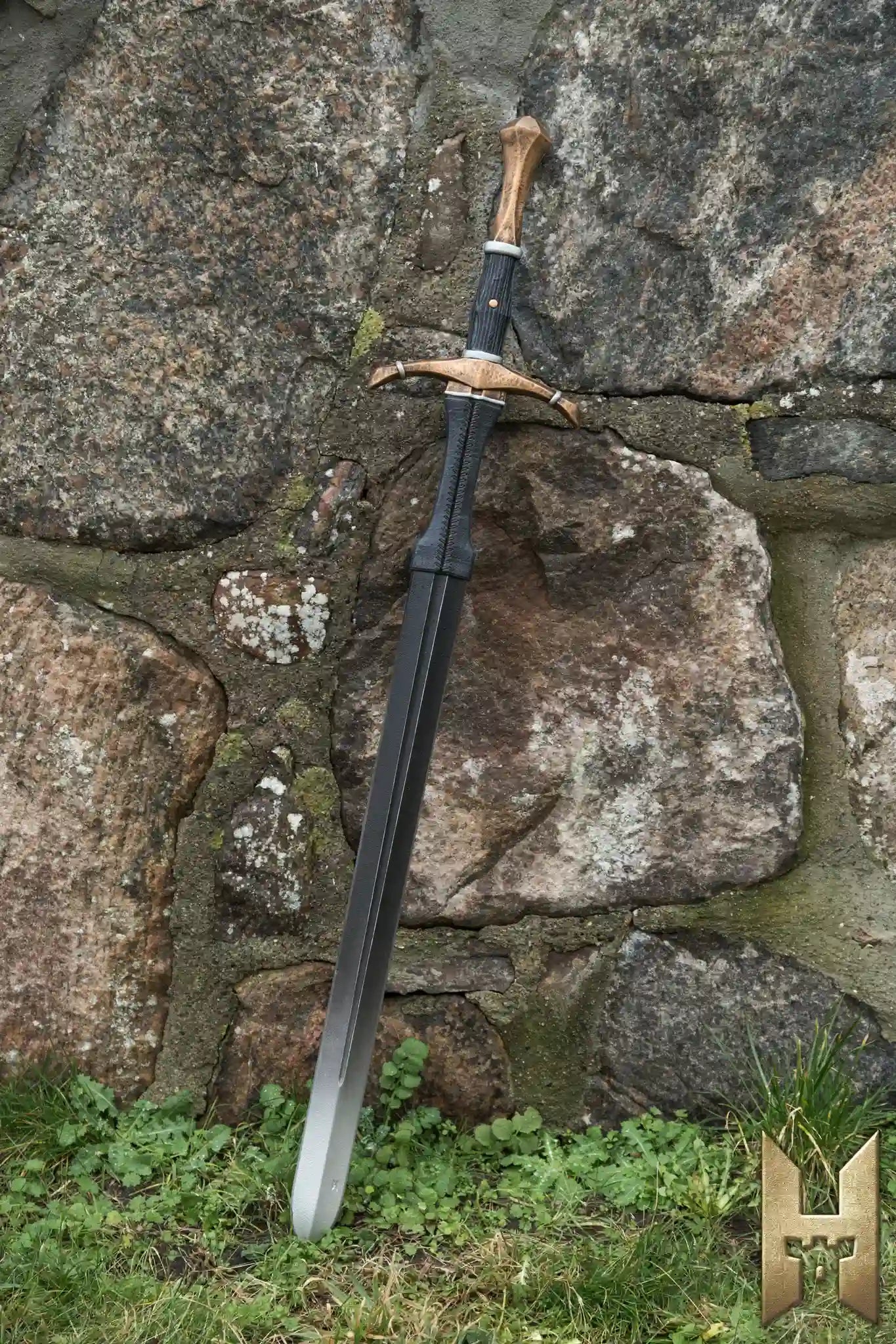 Bastard Sword displayed against a stone wall, showcasing its detailed design and lightweight structure.