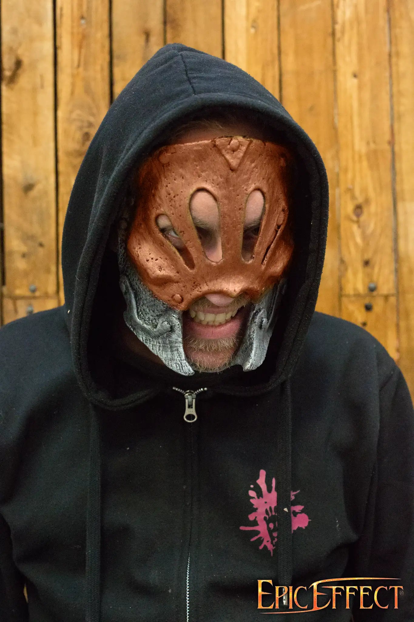 Person wearing a Berserker Trophy Mask, showcasing the detailed design and textures against a wooden background.