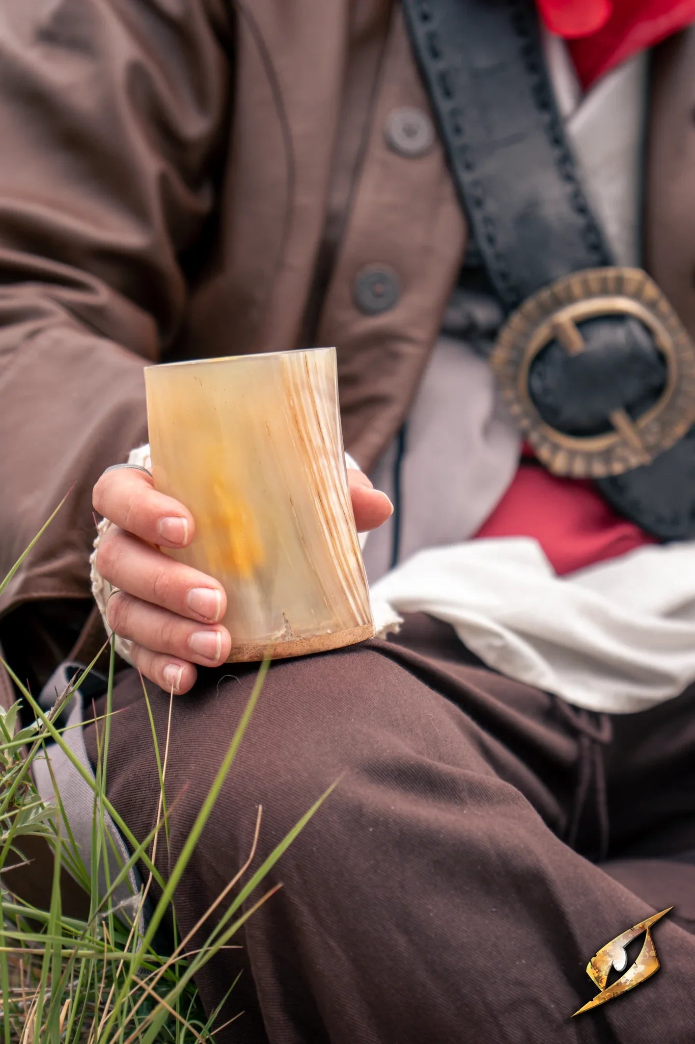 Adventurer Horn Cup held by a person in a historical costume, showcasing its unique dark horn finish.