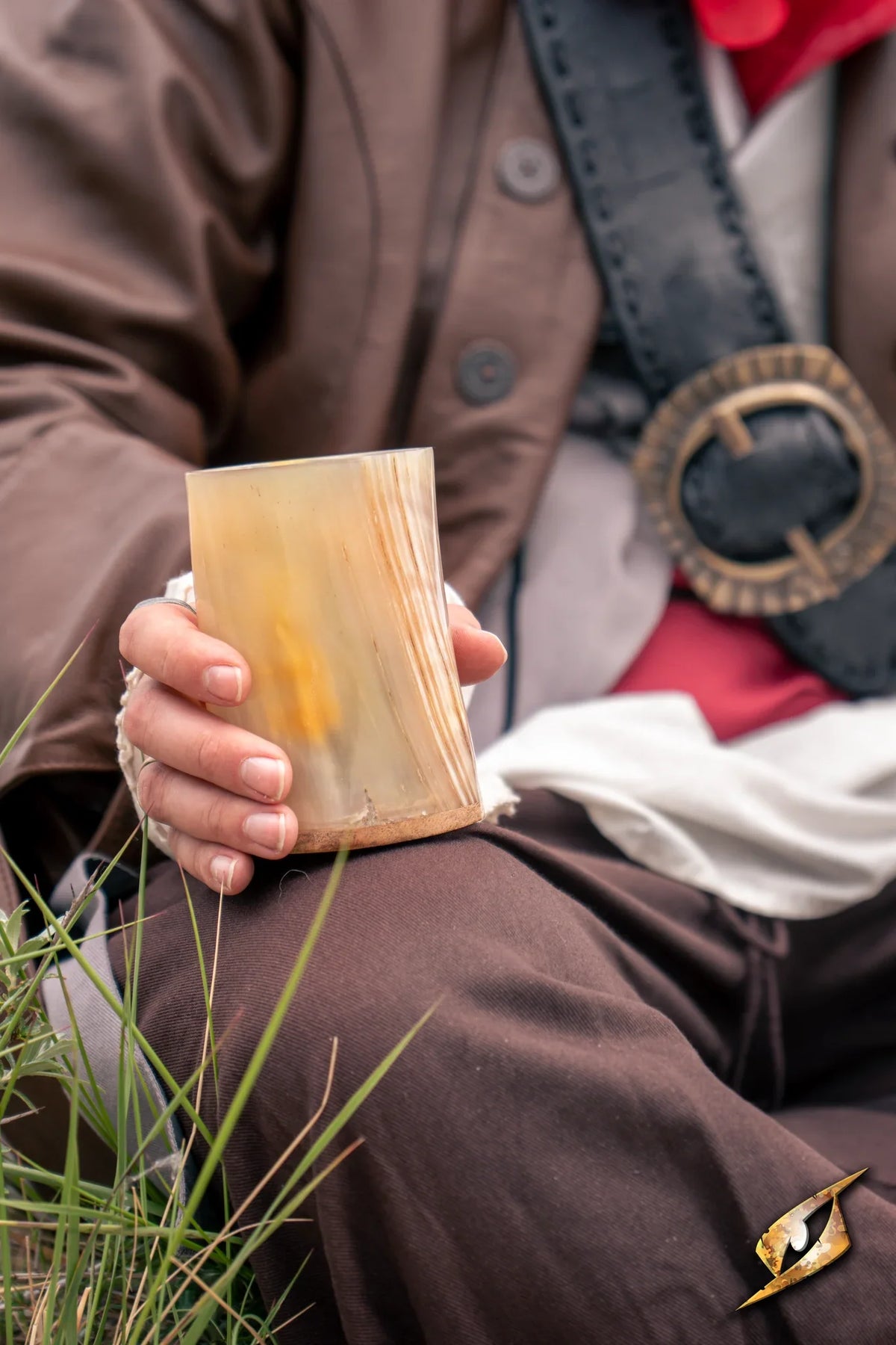Adventurer Horn Cup held by a person in a historical costume, showcasing its unique dark horn finish.