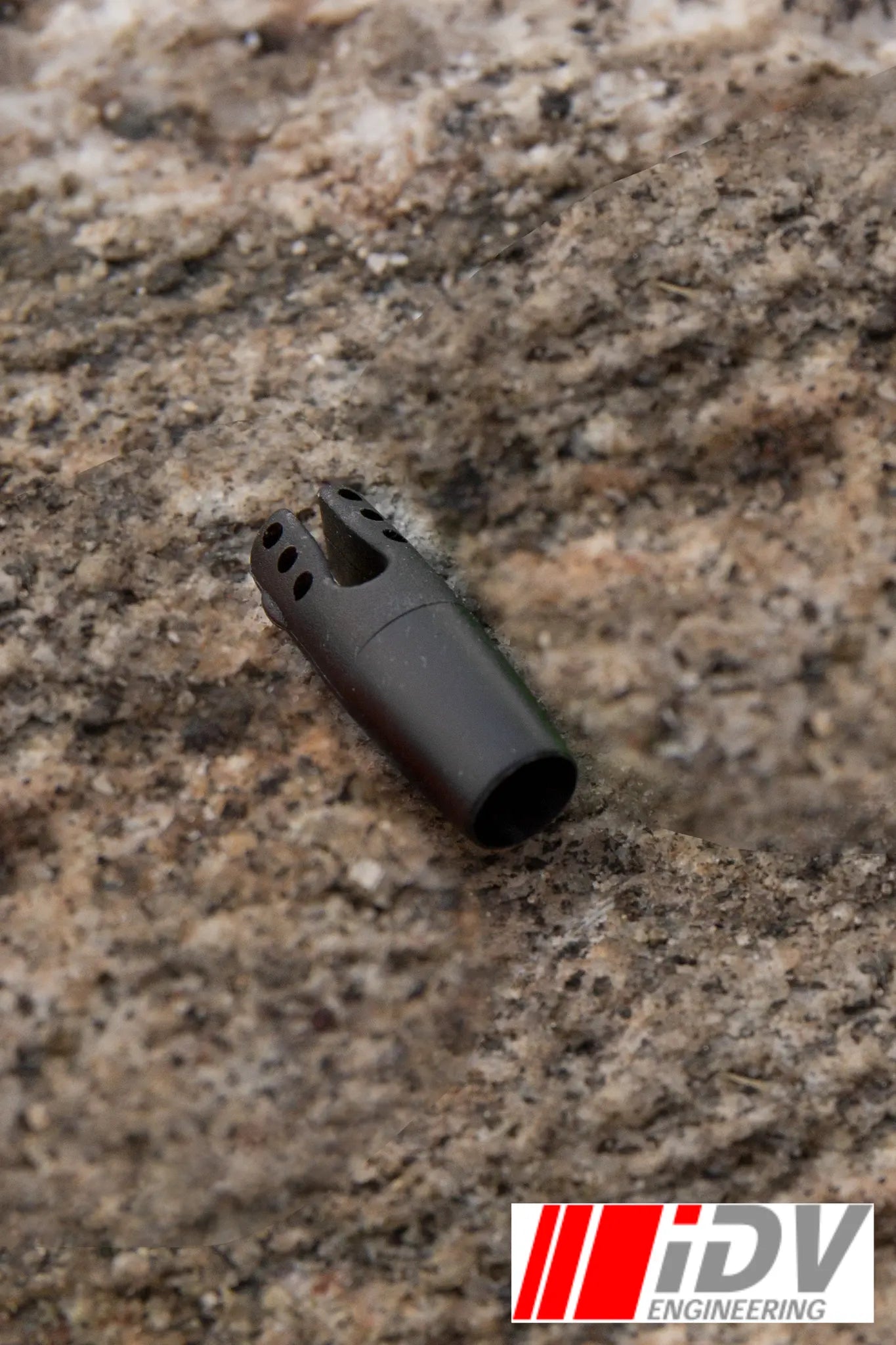 Nock for Larp Arrows by iDV Engineering in black color on a natural stone background.