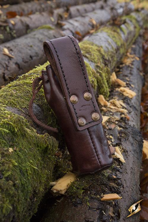 Telescope With Leather Pouch - Brass resting on mossy logs in an outdoor setting.