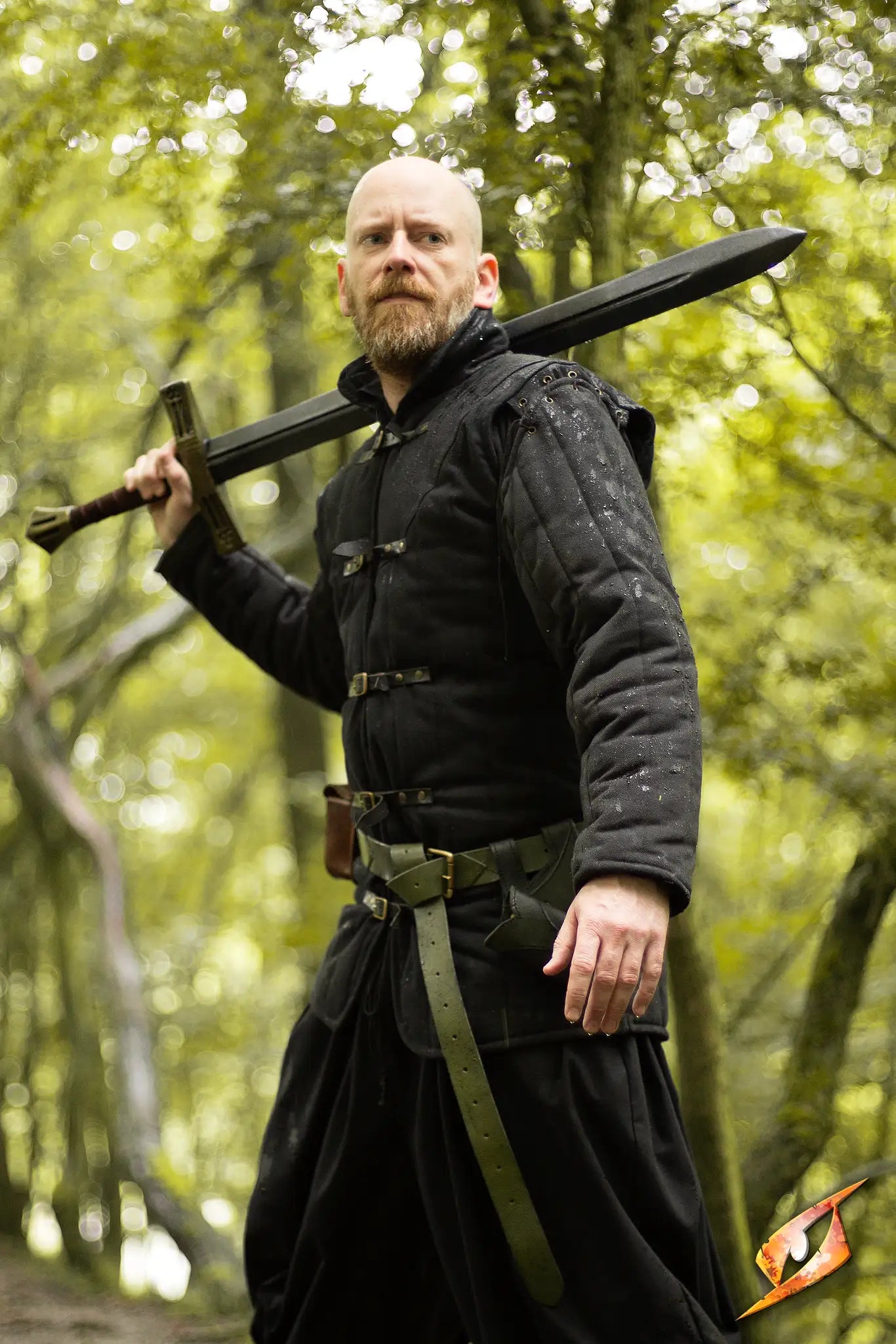 Gambeson Warrior With Long Sleeves wielding a sword in a forest, portraying strength and valor.