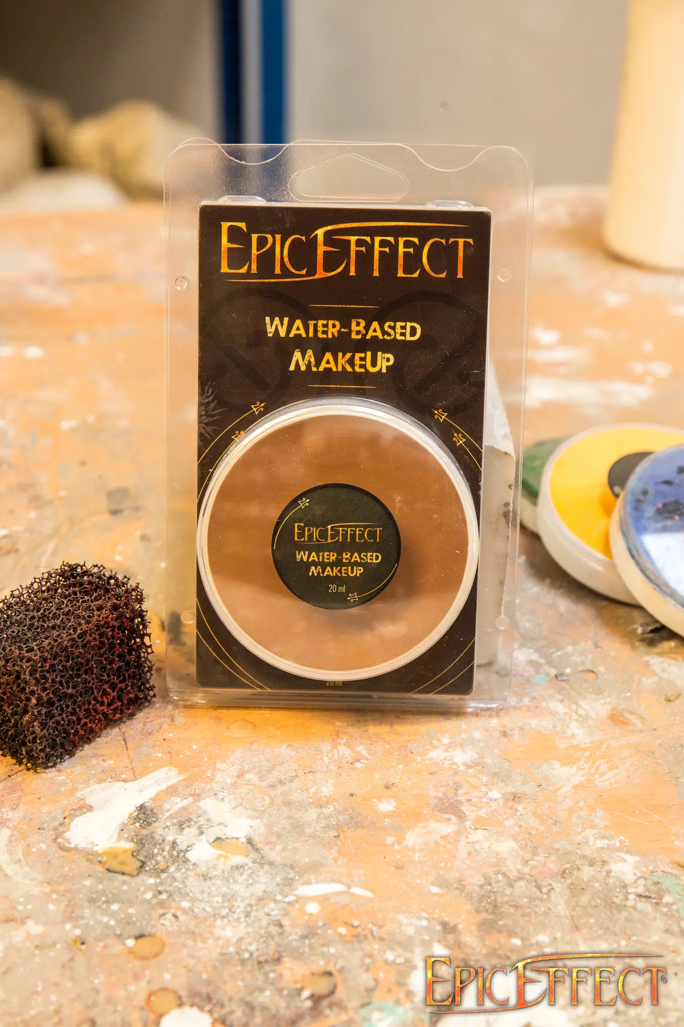 Epic Effects Water Based Make Up - Gold 20 ml compact powder displayed on a work surface.