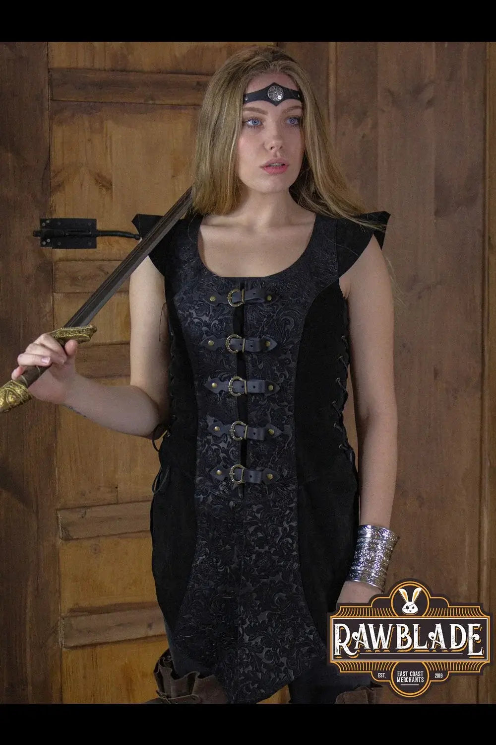 Ylenne Deluxe Long Doublet showcased by a model, featuring embossed leather and hand riveted buckles.